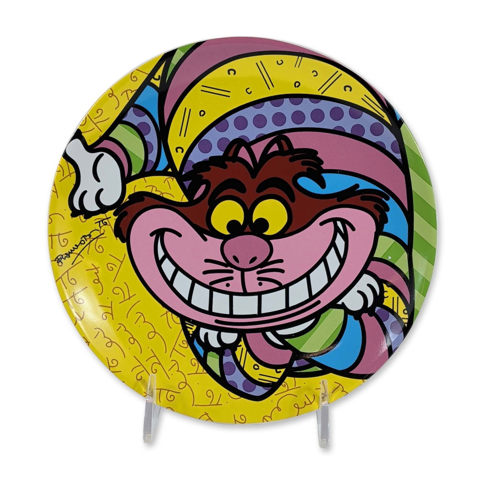 Disney by Britto Cheshire Cat Ceramic Plate: Romero Britto for Disney. Decorative plate in glazed ceramic featuring a neo-pop rendition of the Cheshire Cat from Alice in Wonderland. The design incorporates vibrant colors and multi-patterned