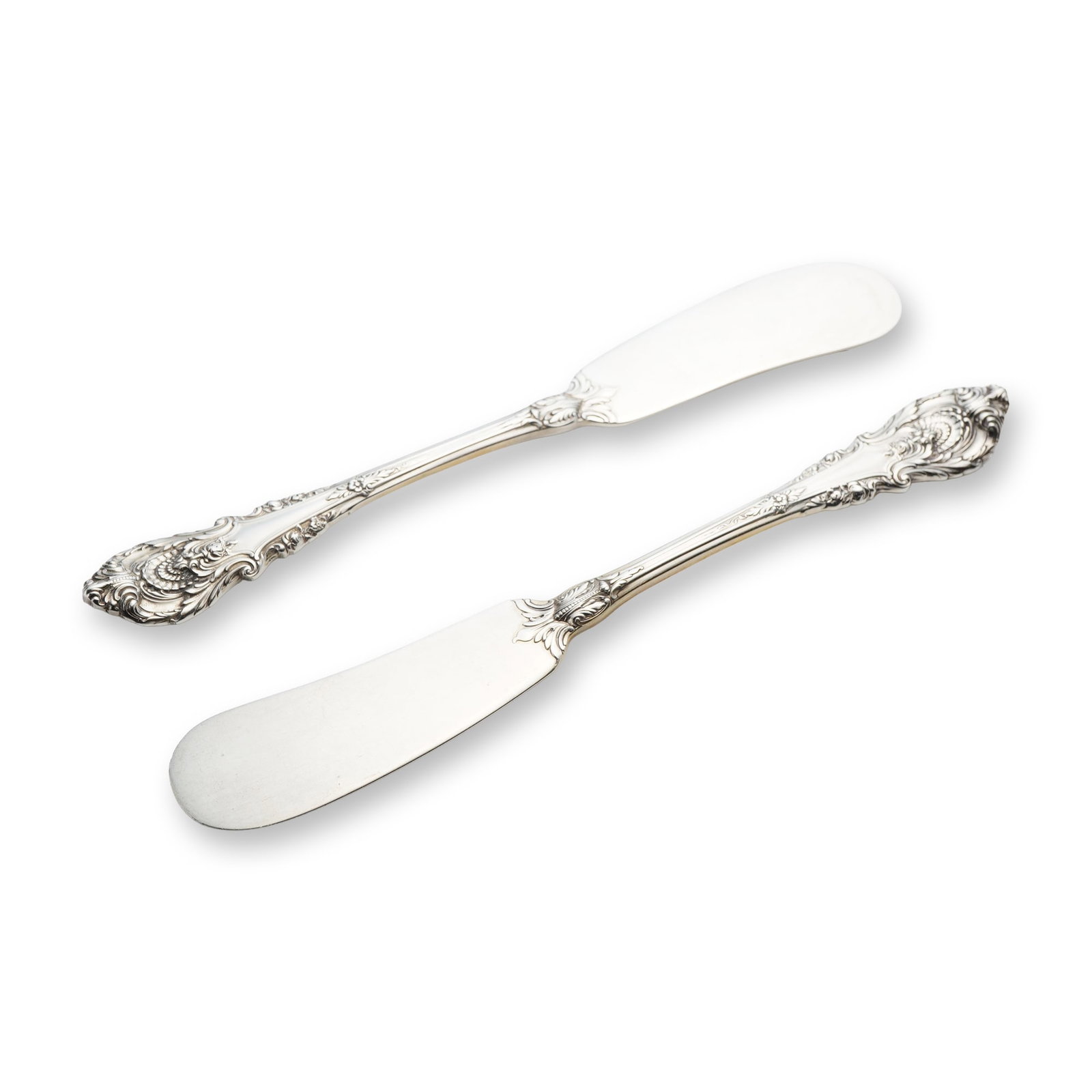 A Pair of Wallace Sterling Silver Sir Christopher Pattern Flat Handle Butter Spreaders: This pair of flat handle butter spreaders is crafted in the Sir Christopher pattern by Wallace Silversmiths. Each piece features a wide paddle blade and highly ornate handles decorated with