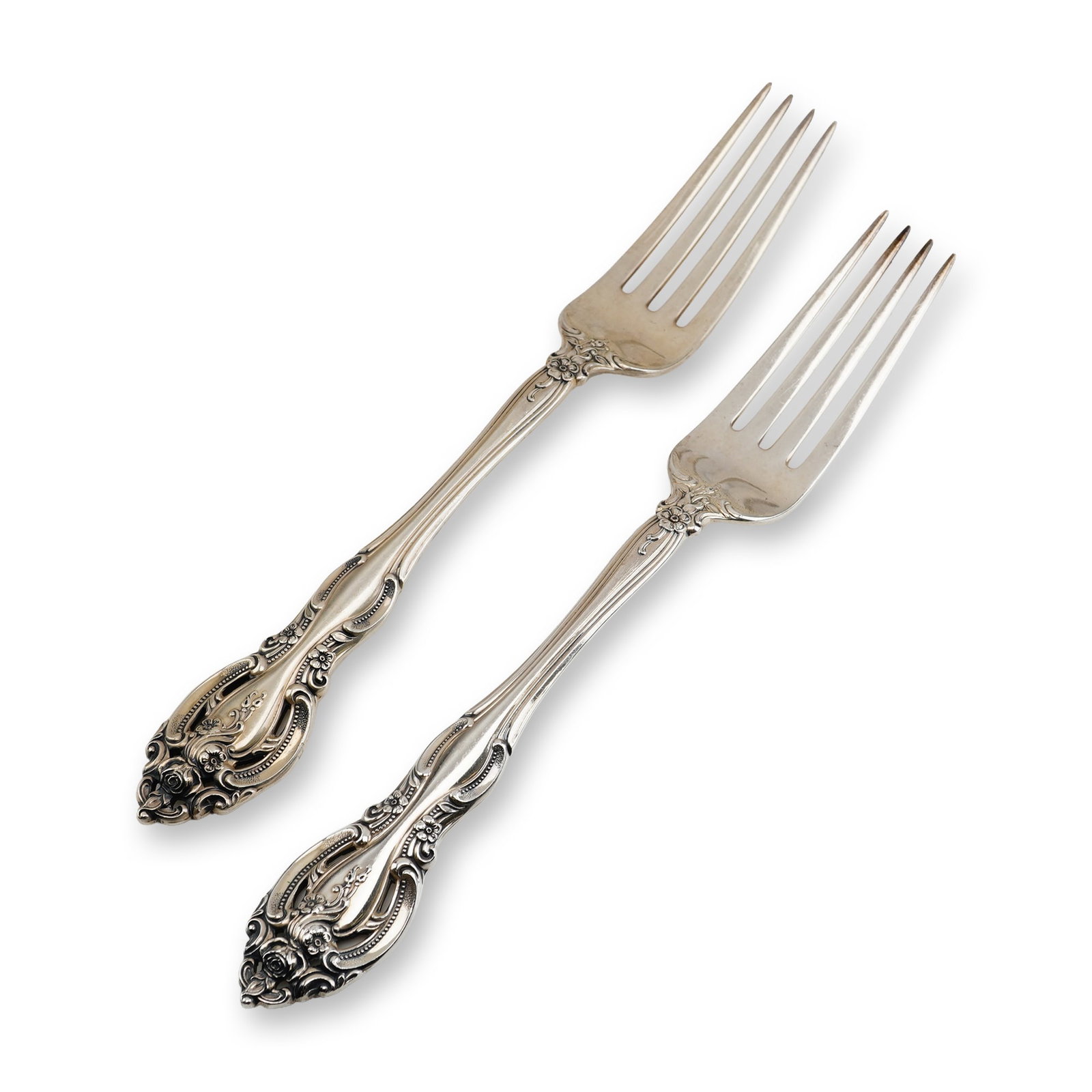 2pc Gorham Sterling Silver Dinner Forks, La Scala: An ornate Rococo Revival style, featuring heavy scrollwork and deeply chased rose floral motifs. A distinguishing feature of this design is the pierced or openwork terminal on the handle. Each fork is