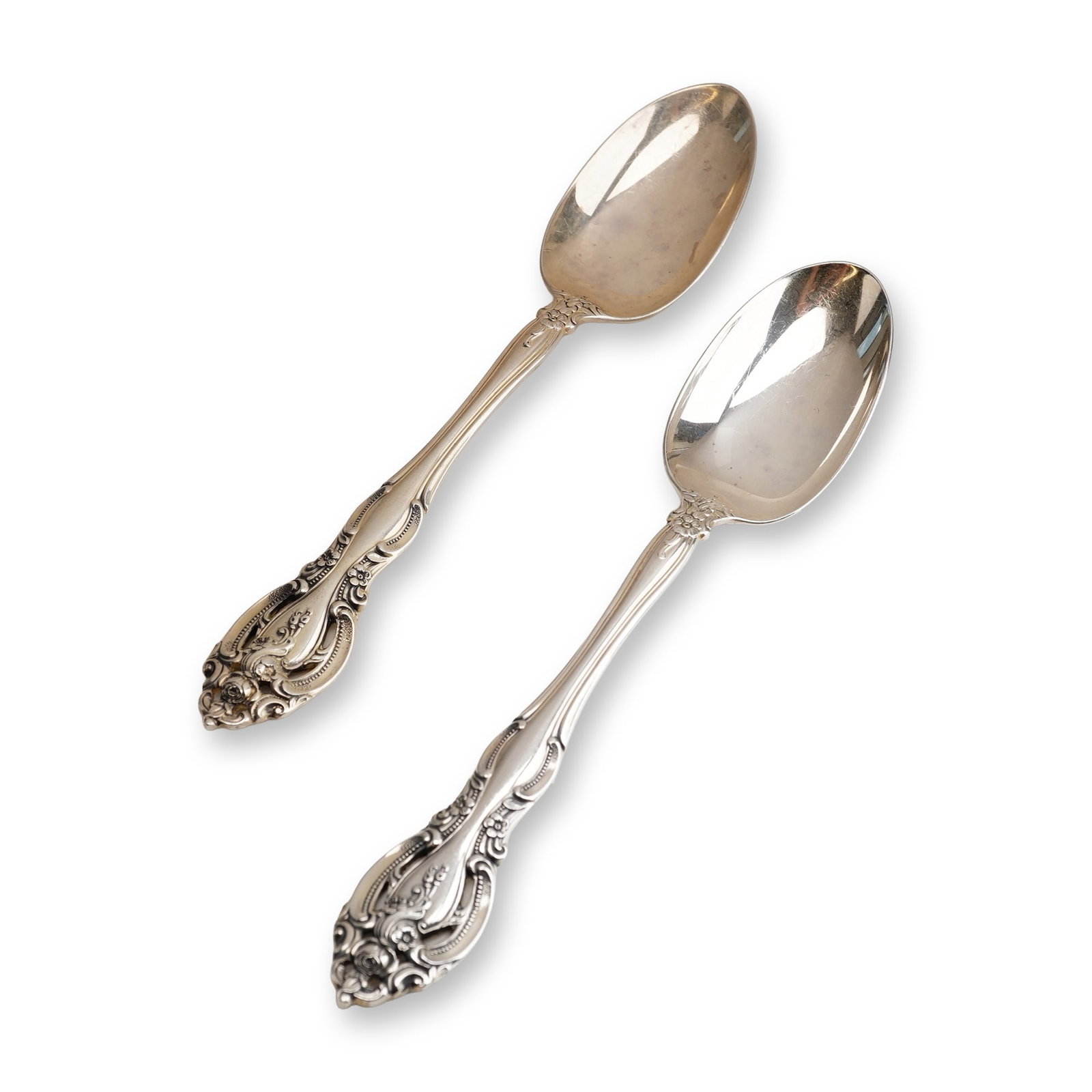 2pc Gorham Sterling Silver Teaspoon, La Scala: The handles feature a Rococo Revival design with ornate scrolled borders, openwork accents, and relief floral sprays including roses. The bowls are of a standard oval form. The reverse of each handle 