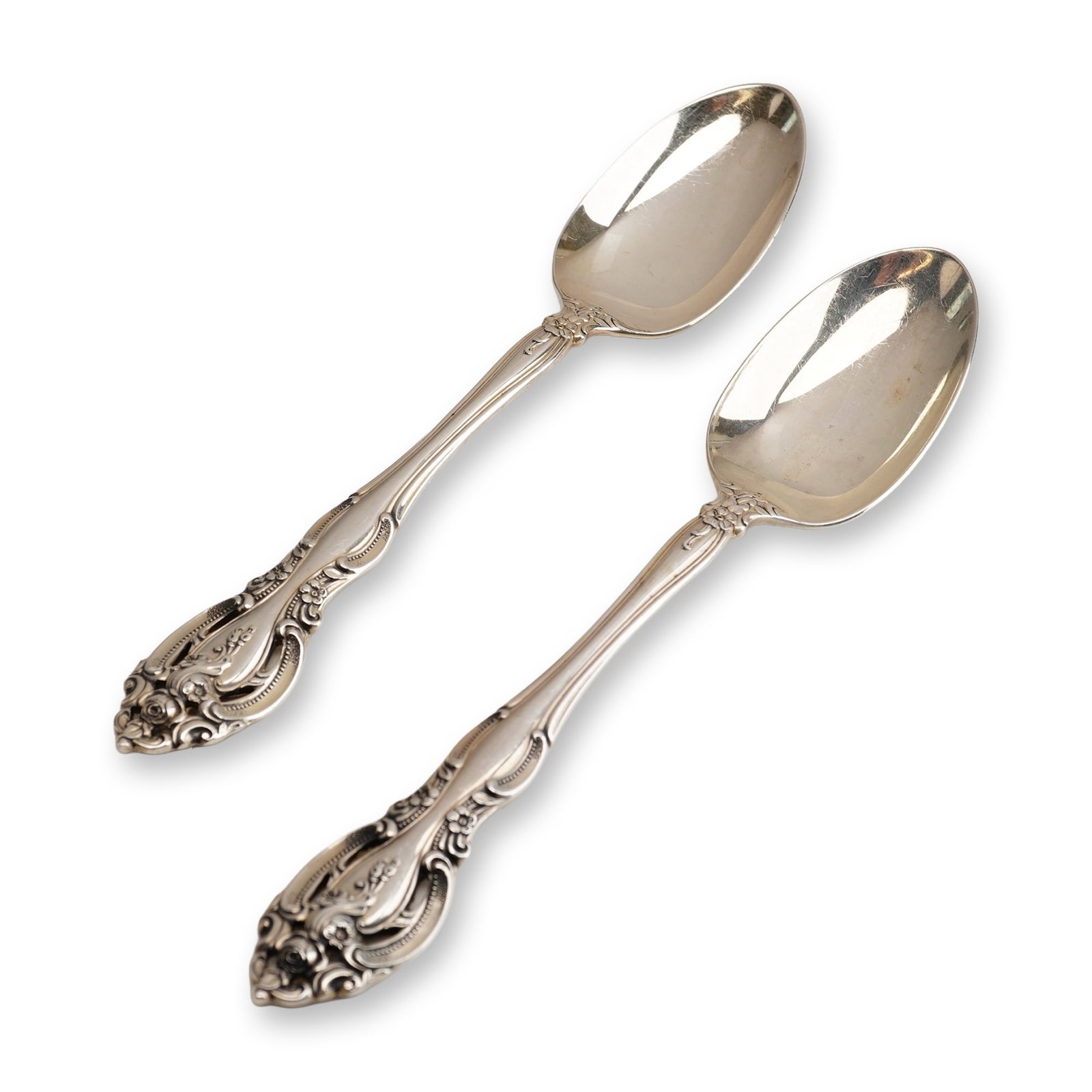 2pc Gorham Sterling Silver Teaspoon, La Scala: First introduced in 1964, the pattern is designed in a highly ornate Rococo Revival style characterized by deep relief scrollwork, acanthus leaves, and rose blossoms. A defining feature of the design