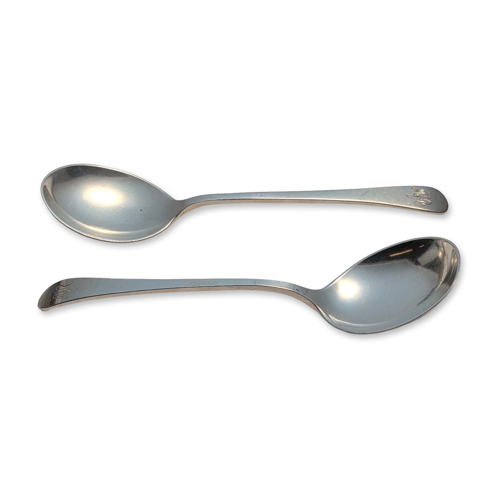 2pc Tuttle Silver Company Sterling Silver Round Soup Spoons, Hannah Hull: Two sterling silver soup spoons featuring plain handles with engraved stylized monograms on the handle terminals. The reverse of each handle is marked STERLING and displays the Tuttle Silver Company h