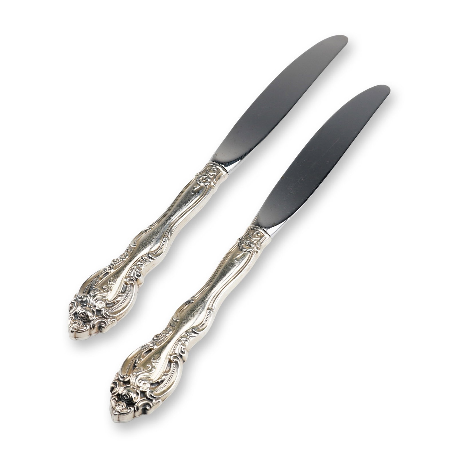 2pc Gorham Sterling Silver and Stainless Steel Dinner Knives, La Scala: This pair of dinner knives was produced by the Gorham Manufacturing Company in the highly decorative La Scala pattern. Characterized by its Rococo-revival aesthetic, the pattern features dense scrollw