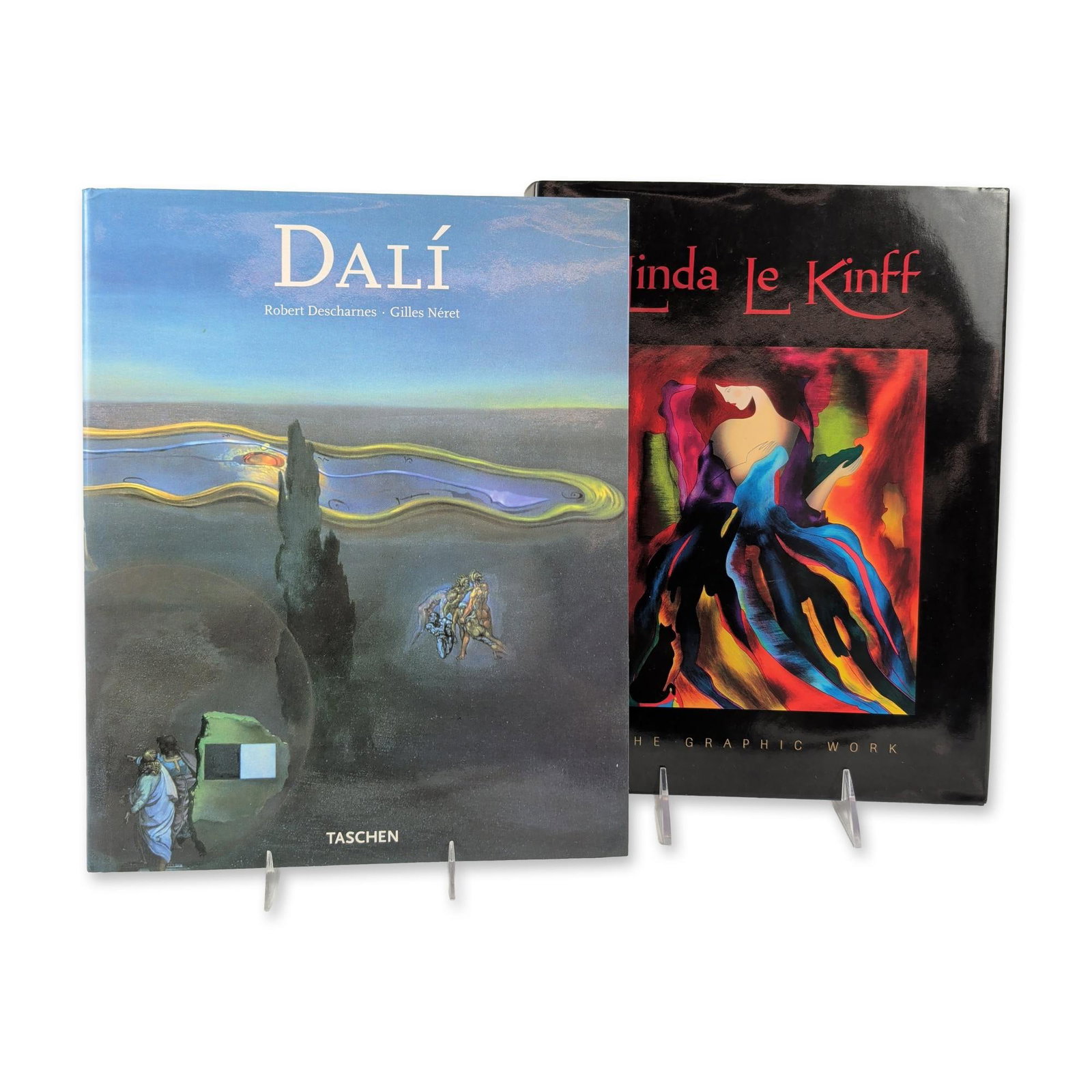 2pc Salvador Dali and Linda Le Kinff Hardcover Art Books: Collection of two hardcover art monographs. Includes Dali by Robert Descharnes and Gilles Neret, published by Taschen, featuring the work Searching for the Fourth Dimension on the cover. The second vo