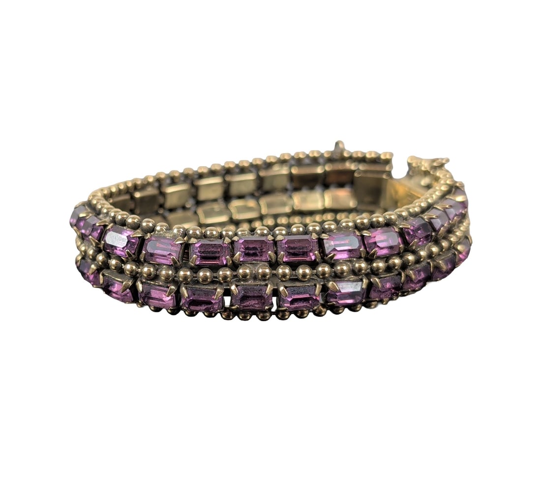 Kramer Purple Rhinestone Link Bracelet: Kramer of New York. Triple-row bracelet in gold-tone metal, featuring rectangular emerald-cut purple rhinestones set in parallel rows. Stones are secured in multi-prong settings and separated by rows 