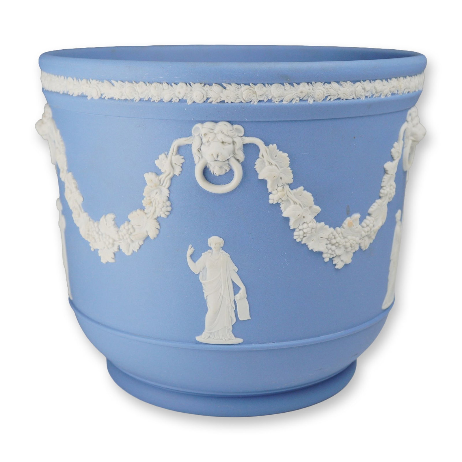Wedgwood Pale Blue Jasperware Neoclassical Cachepot: A Wedgwood pale blue jasperware cachepot of cylindrical form with a slightly tapered base. The vessel is constructed of stoneware featuring a matte blue ground with applied white bas-relief sprigged d