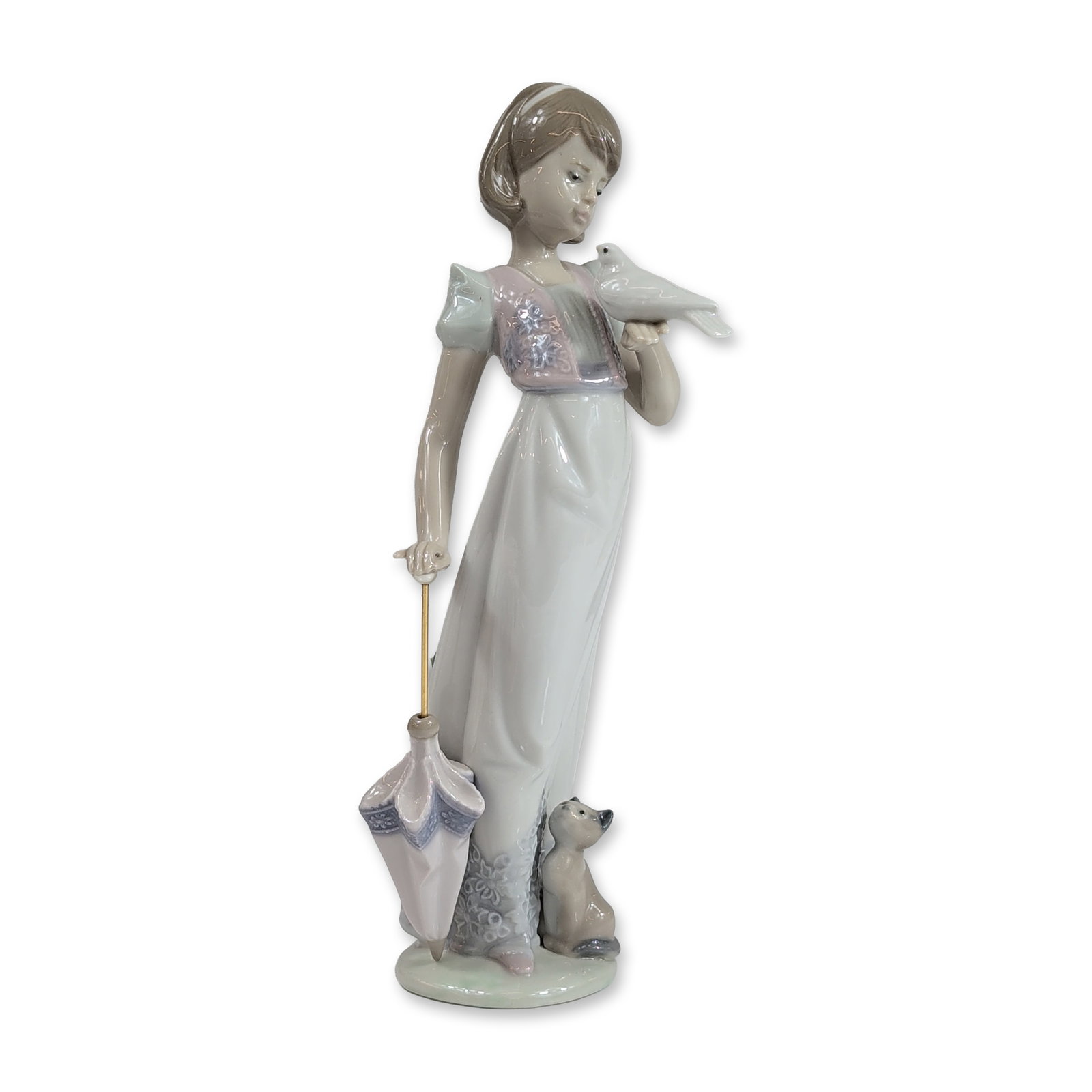 Lladro Spanish Porcelain Summer Stroll Figurine: Lladro (Spain). Summer Stroll (model 7611) glazed porcelain figurine, featuring a young woman in a gown holding a dove, accompanied by a kitten and a parasol with a gold-tone metal rod. Base features 
