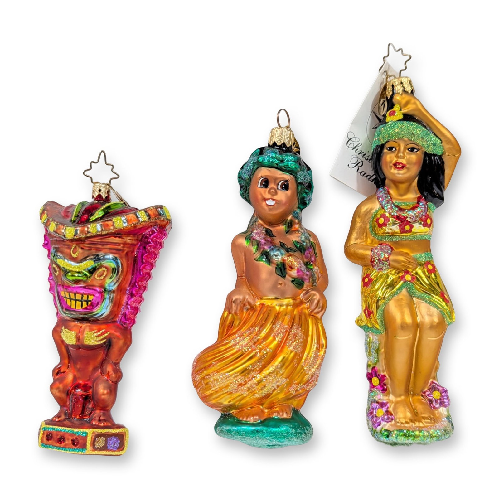 3pc Christopher Radko Tropical Hawaiian Glass Ornaments: Christopher Radko. Three hand-painted, mouth-blown glass Christmas ornaments with a tropical Hawaiian theme. The collection includes a stylized red and pink Tiki idol on a hexagonal base, a hula boy