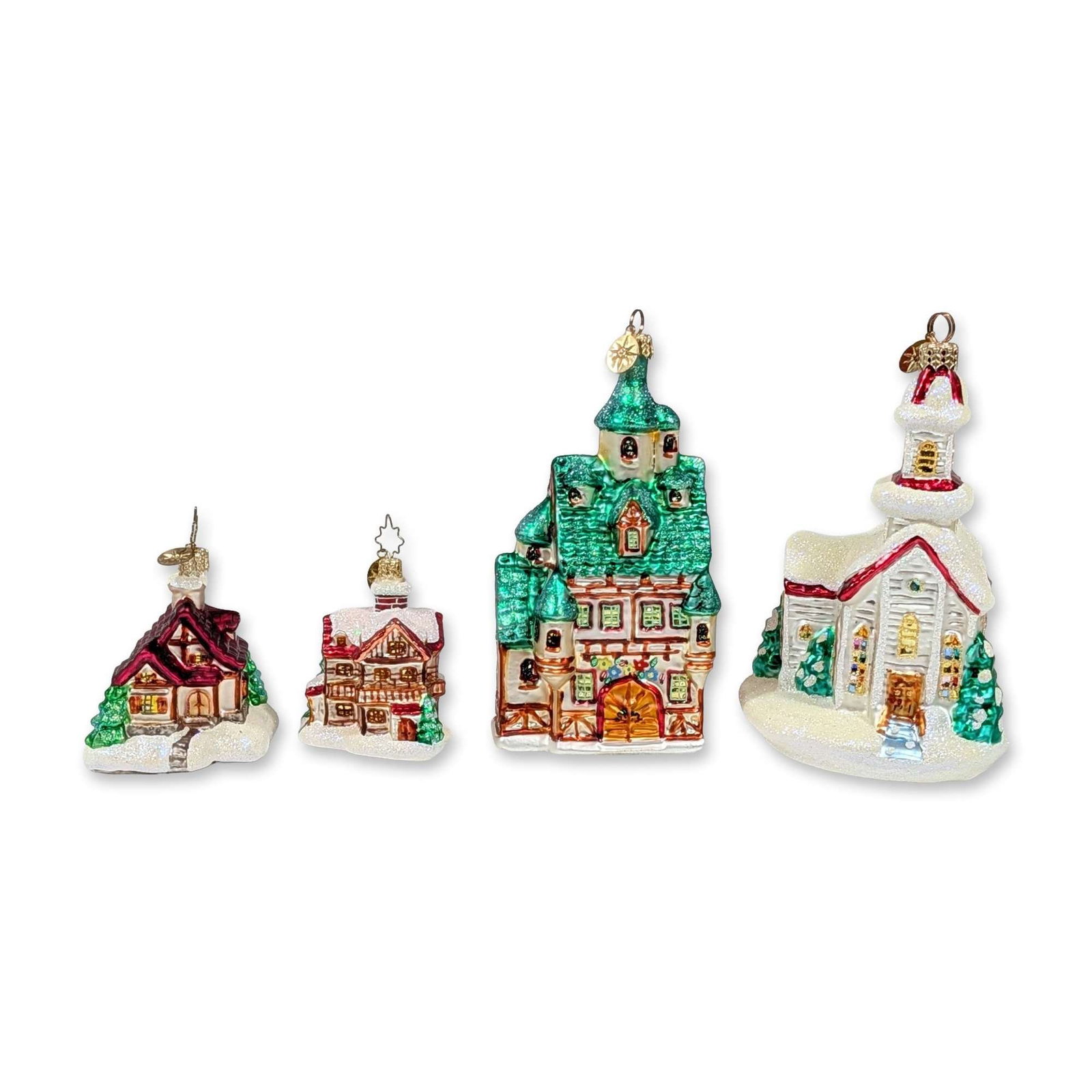 4pc Old World Christmas Glass Ornaments: Group of four architectural ornaments in mouth-blown glass, featuring various snow-covered building designs including a cottage, a timber-framed house, a multi-story townhouse with turrets, and a