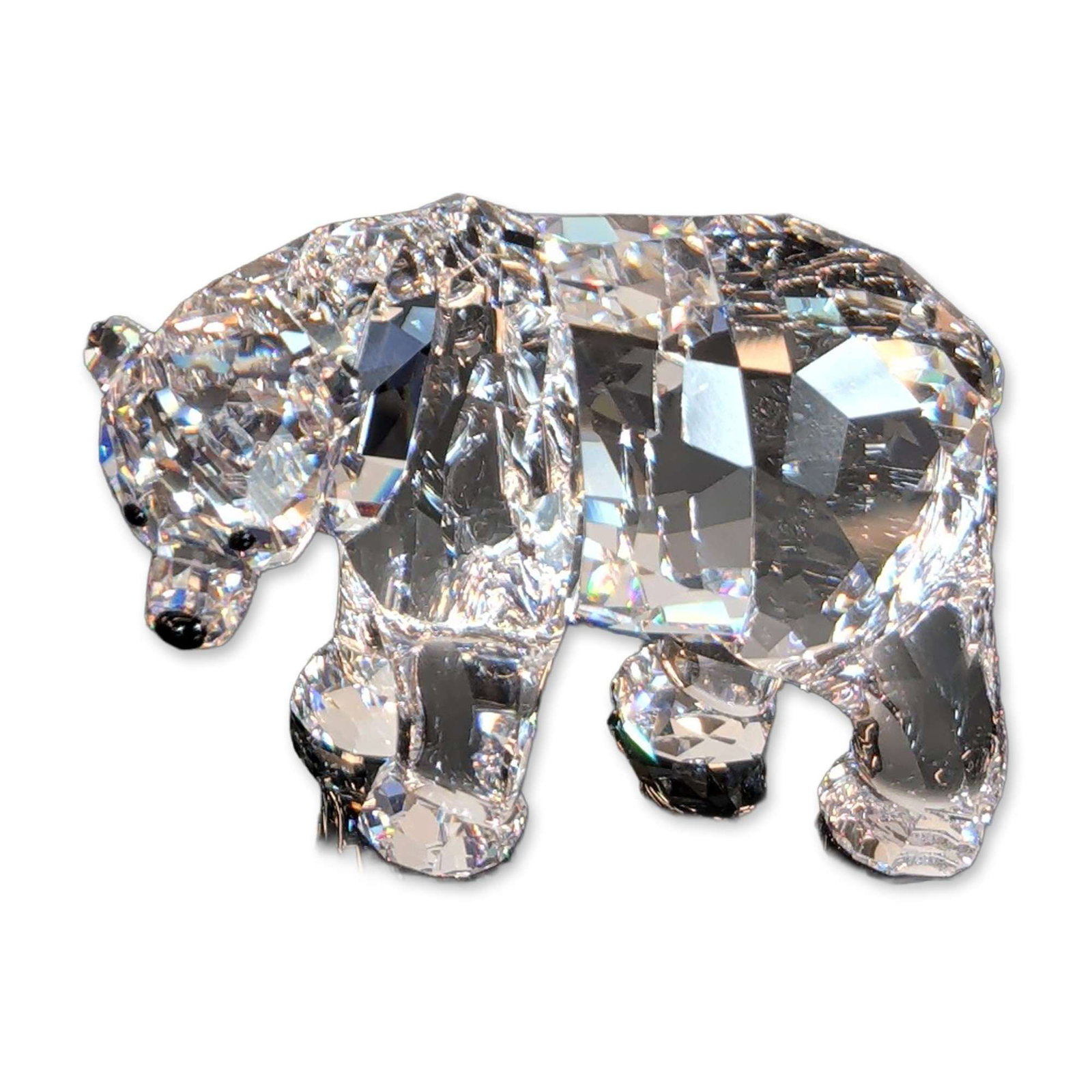 Swarovski Crystal Mother Bear Figurine: Swarovski faceted clear lead crystal walking mother polar bear figurine. The figure is depicted in a walking pose with a lowered head and features black stone accents for the eyes and nose. The base