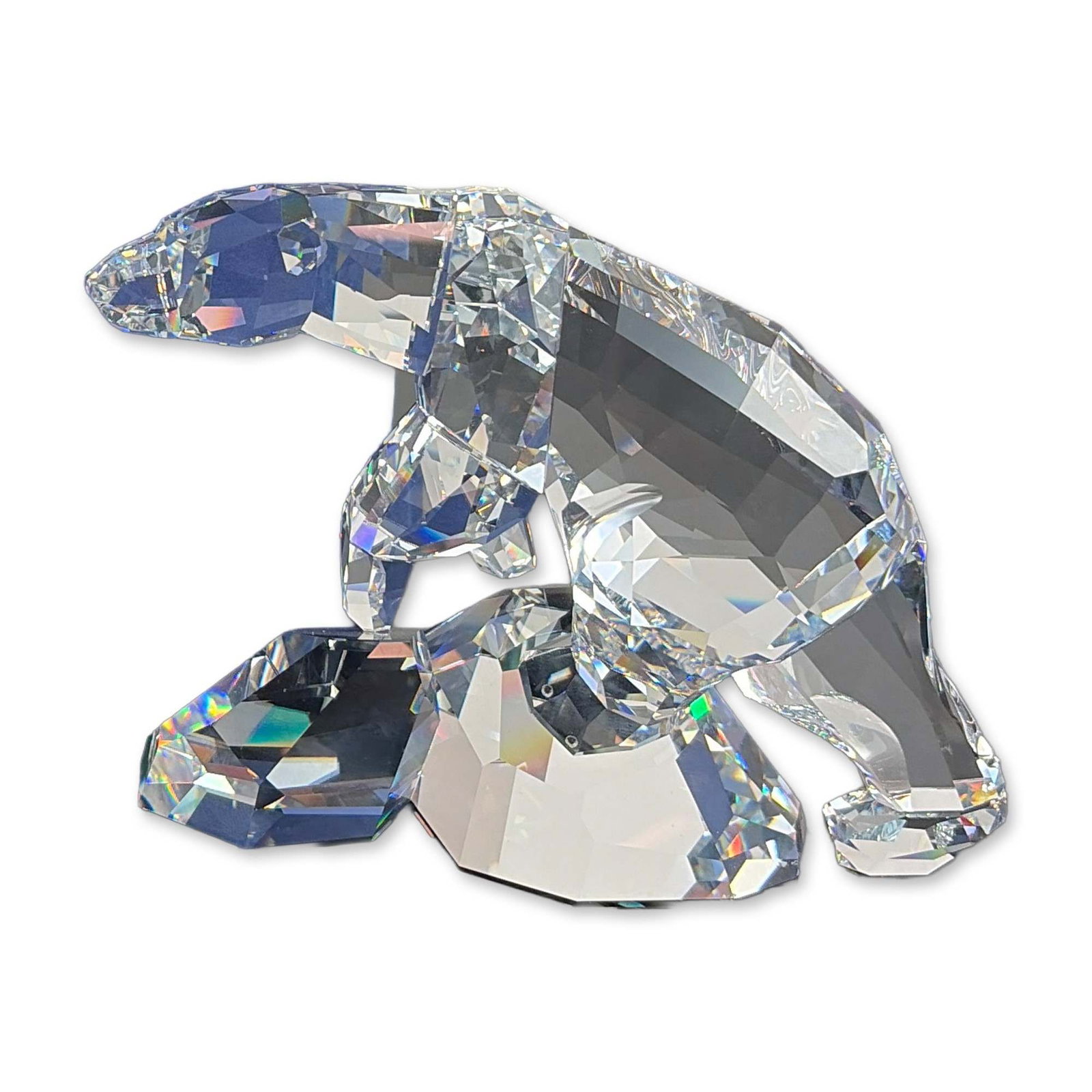 Swarovski Faceted Crystal Nanuc Polar Bear Figurine: Swarovski large faceted lead crystal figurine of a walking polar bear, named Nanuk, showcases exquisite craftsmanship with intricate facets designed to capture and refract light beautifully. The