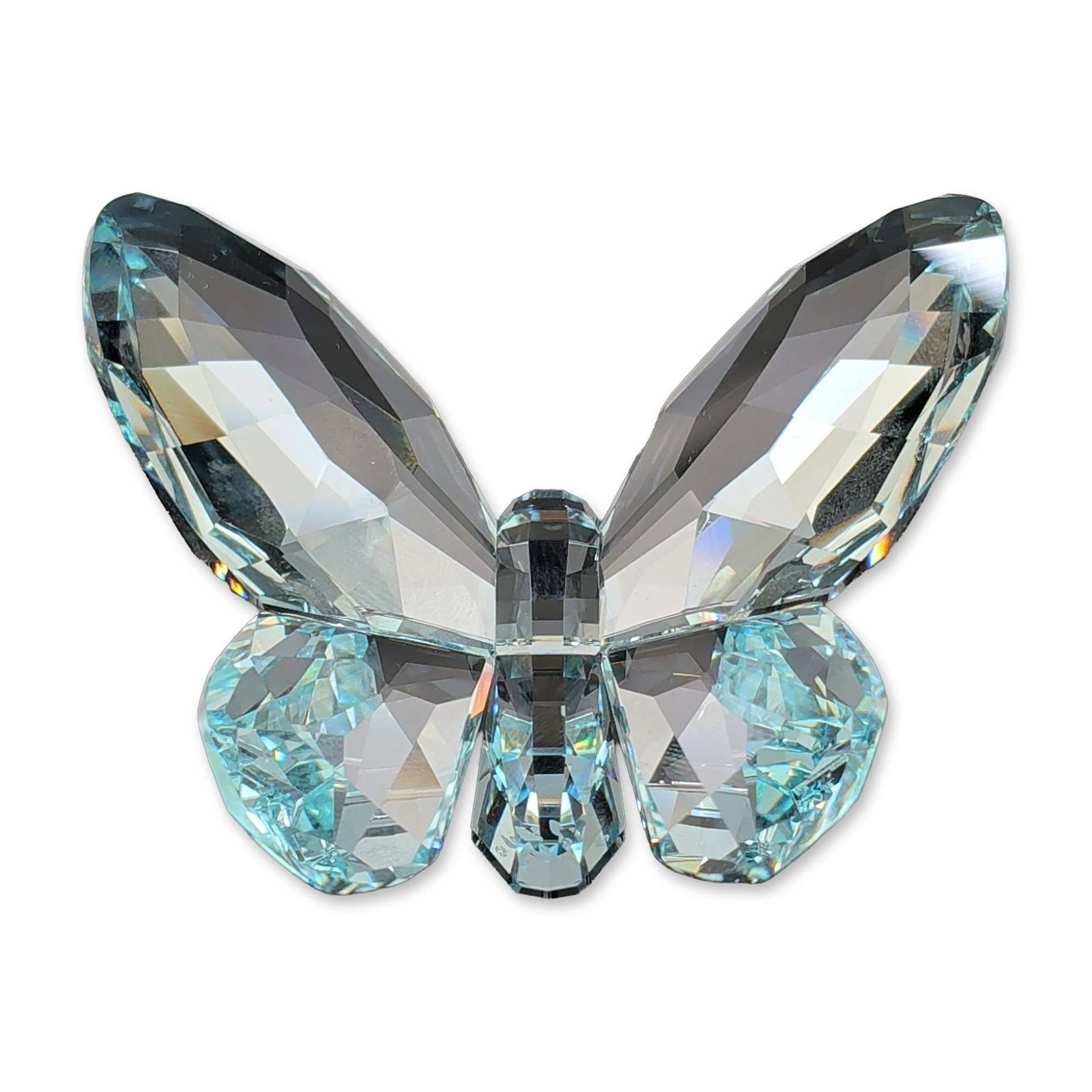 Swarovski Light Azore Crystal Butterfly Figurine: Swarovski brilliant Butterfly figurine in Light Azore faceted lead crystal. The stylized insect form features four distinct faceted wings and a multi-faceted, segmented body. An etched frosted