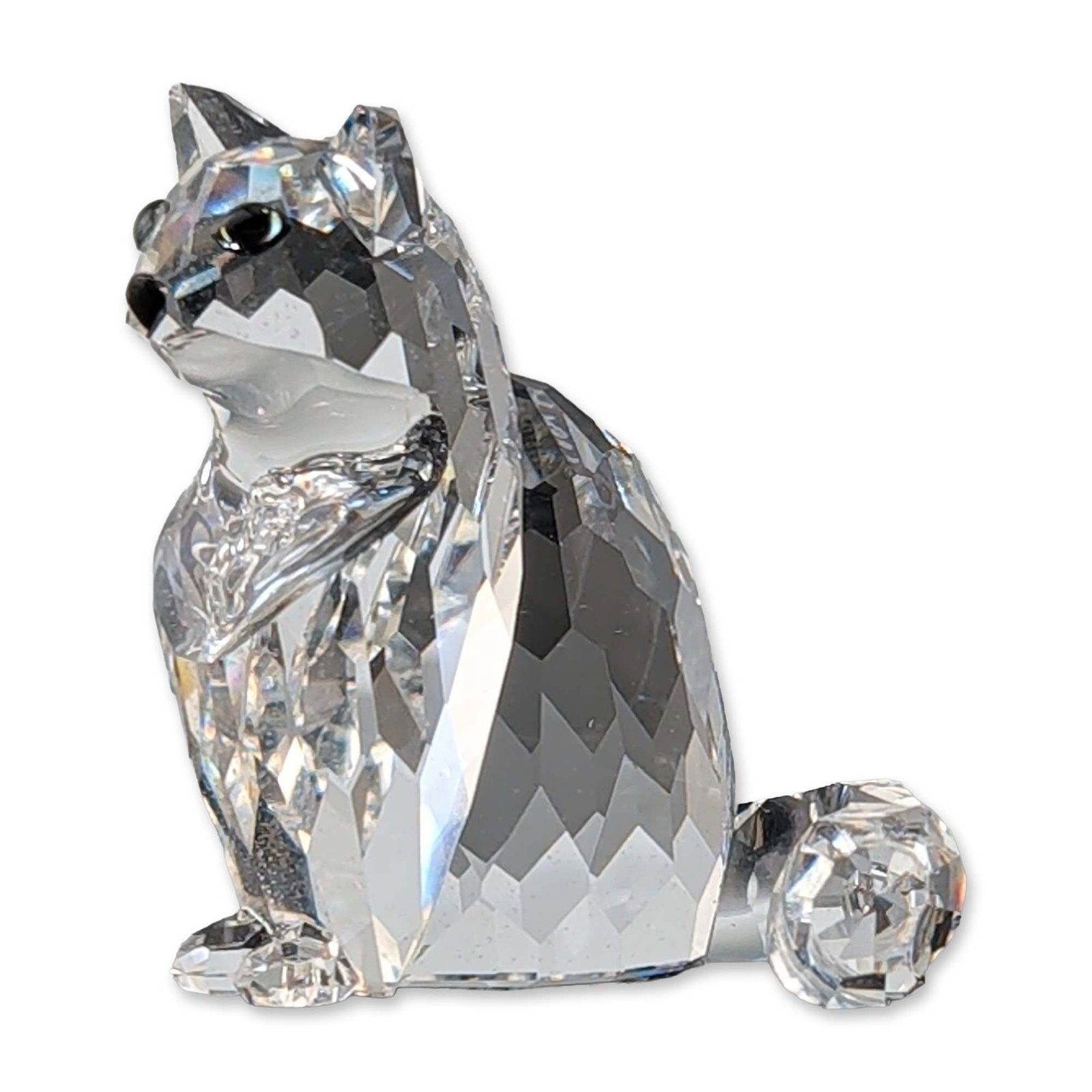 Swarovski Silver Crystal Sitting Cat Figurine, Signed: Swarovski clear faceted lead crystal figurine depicting a sitting cat. The piece features a stylized faceted body, curved tail, and inset bead eyes. Marked with an acid-etched swan logo to the undersi