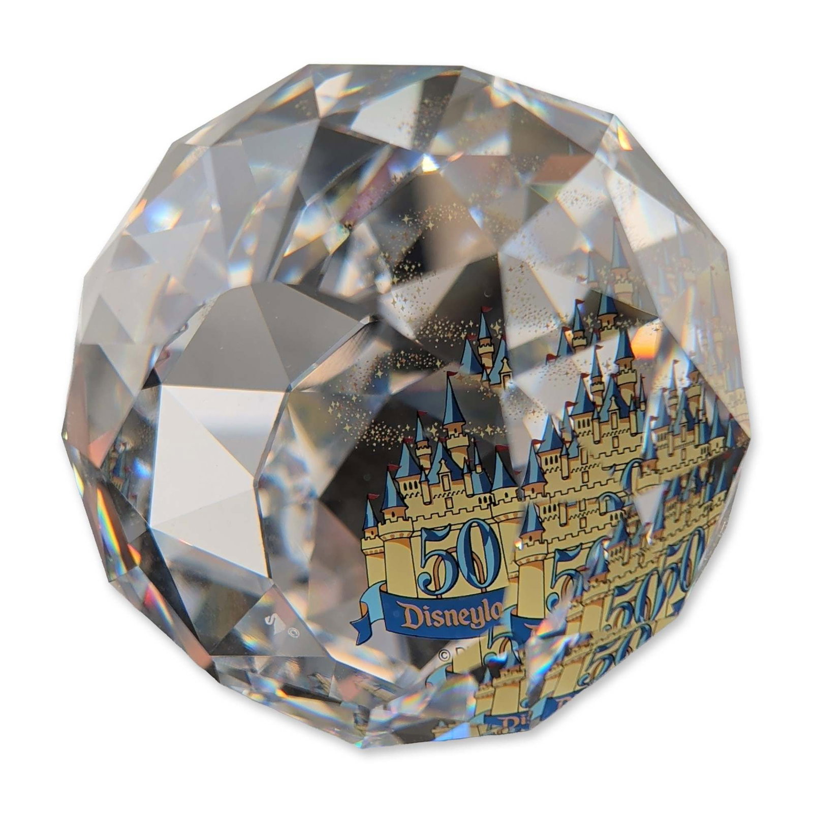 Swarovski Crystal Disneyland 50th Anniversary Commemorative Paperweight: Swarovski faceted clear crystal paperweight commemorating the 50th anniversary of Disneyland. The spherical form features multiple triangular facets and contains an internal color graphic of the Sleep
