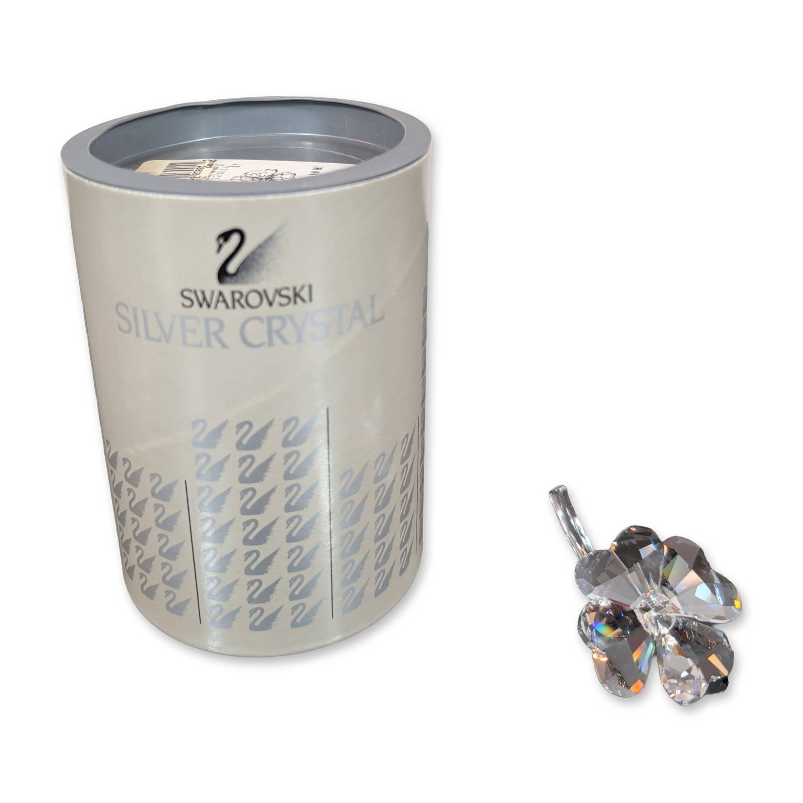 Swarovski Silver Crystal Four-Leaf Clover Figurine: Stylized four-leaf clover figurine in faceted clear lead crystal. The curved stem features a frosted etched swan mark. Accompanied by the original two-part cylindrical presentation box with a silver-t