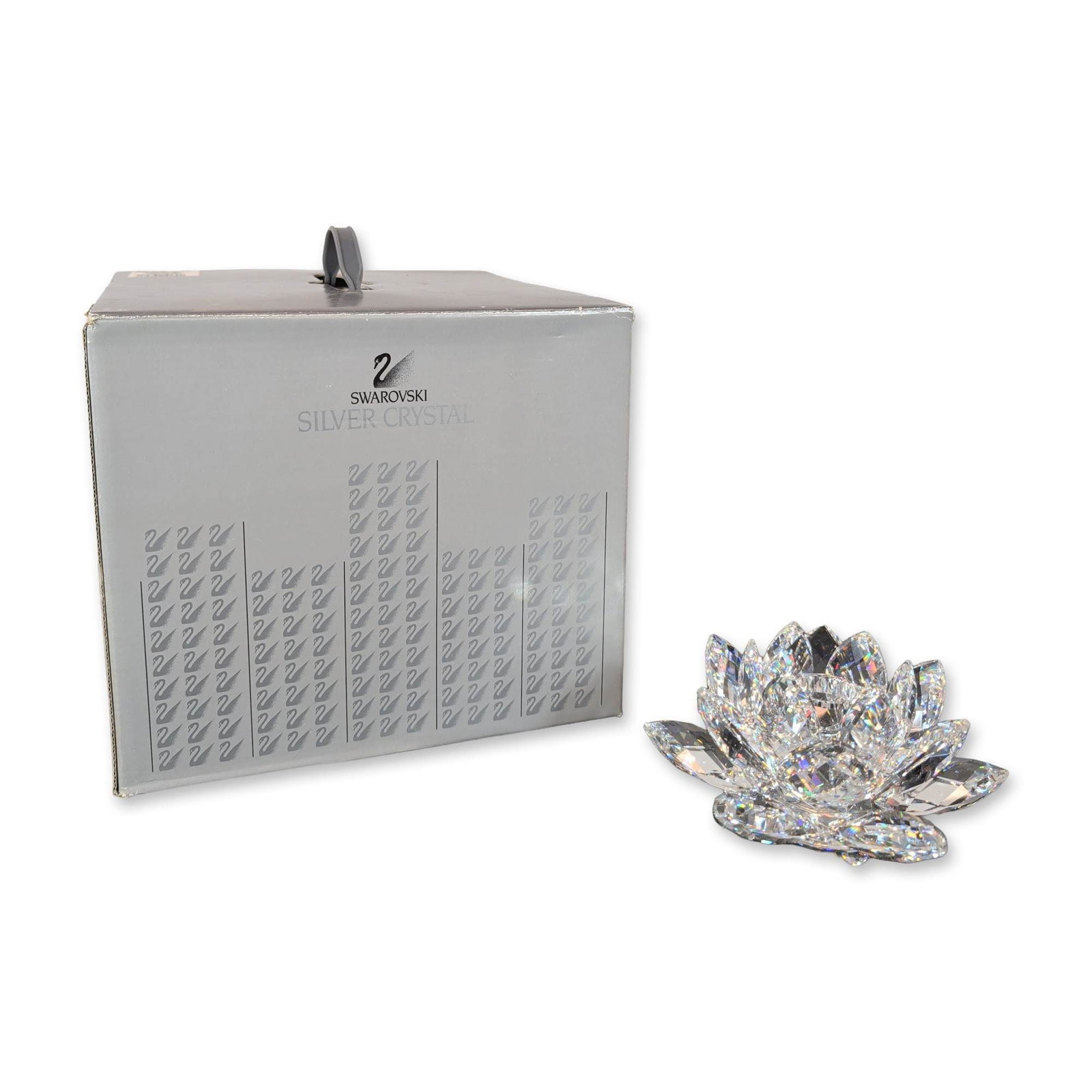 Swarovski Silver Crystal Water Lily Candle Holder: Swarovski lead crystal water lily candle holder from the Silver Crystal collection. Constructed with multiple tiers of faceted petals arranged in a blooming lotus form. Features a circular etched Swar
