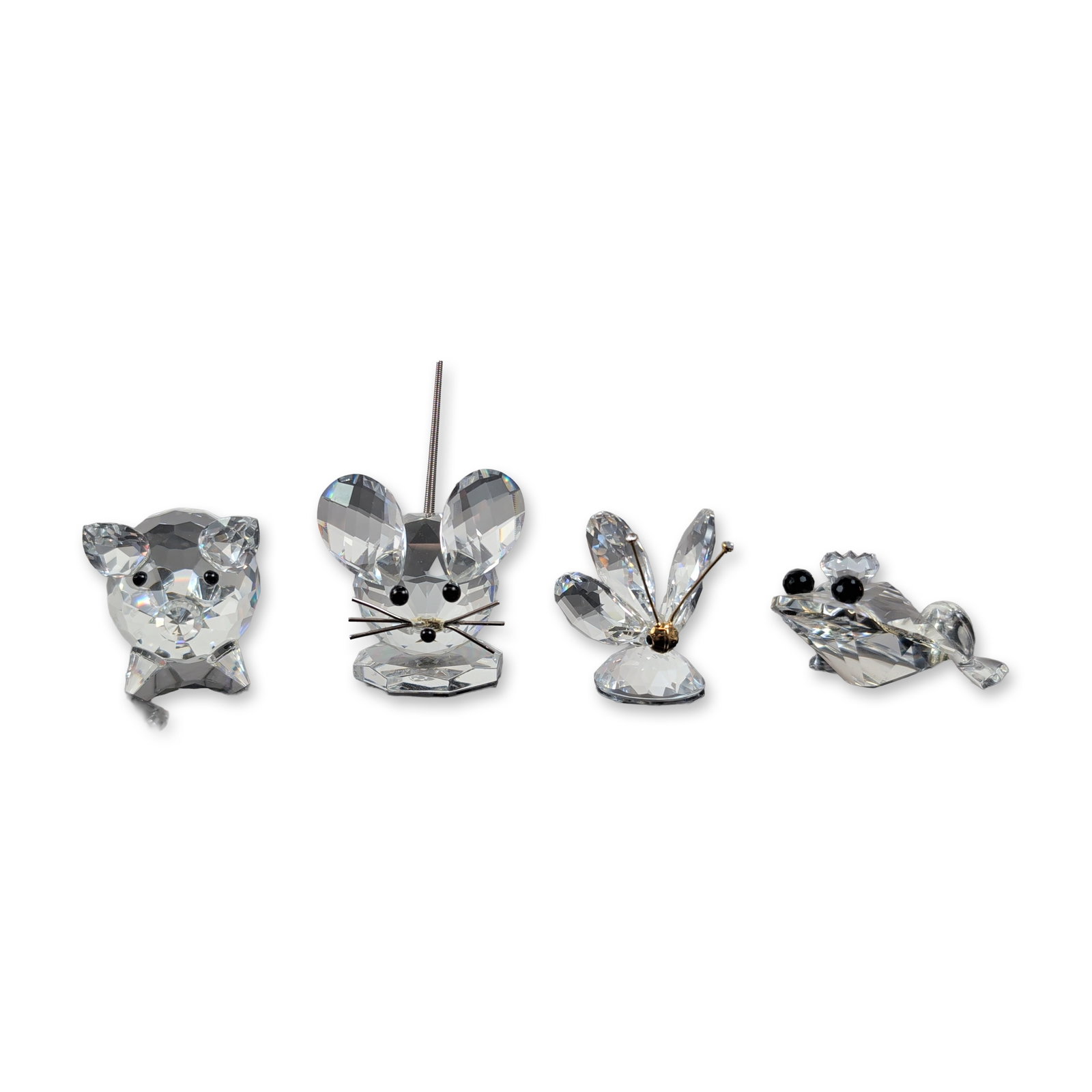 4pc Swarovski Crystal Miniature Animal Collection: A dazzling collection of Swarovski crystal animal figurines crafted in faceted lead crystal, each adorned with charming details like black bead eyes and elegant metal accents. The group includes a pig