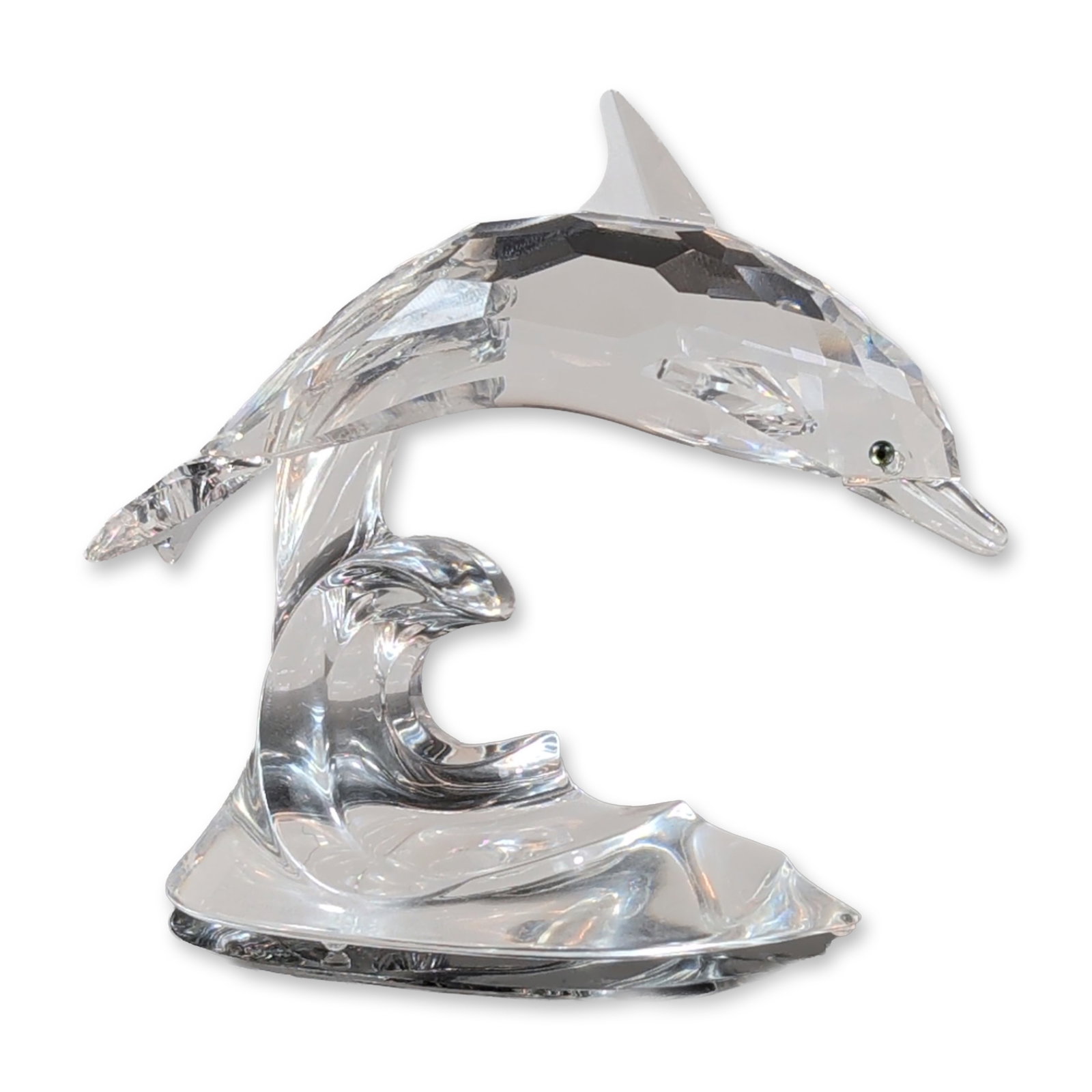 Swarovski Crystal Dolphin on Wave Figurine: Swarovski faceted and smooth crystal figurine depicting a dolphin leaping over a wave, featuring a small dark eye and an acid-etched swan logo on the base. Accompanied by original cylindrical packagin
