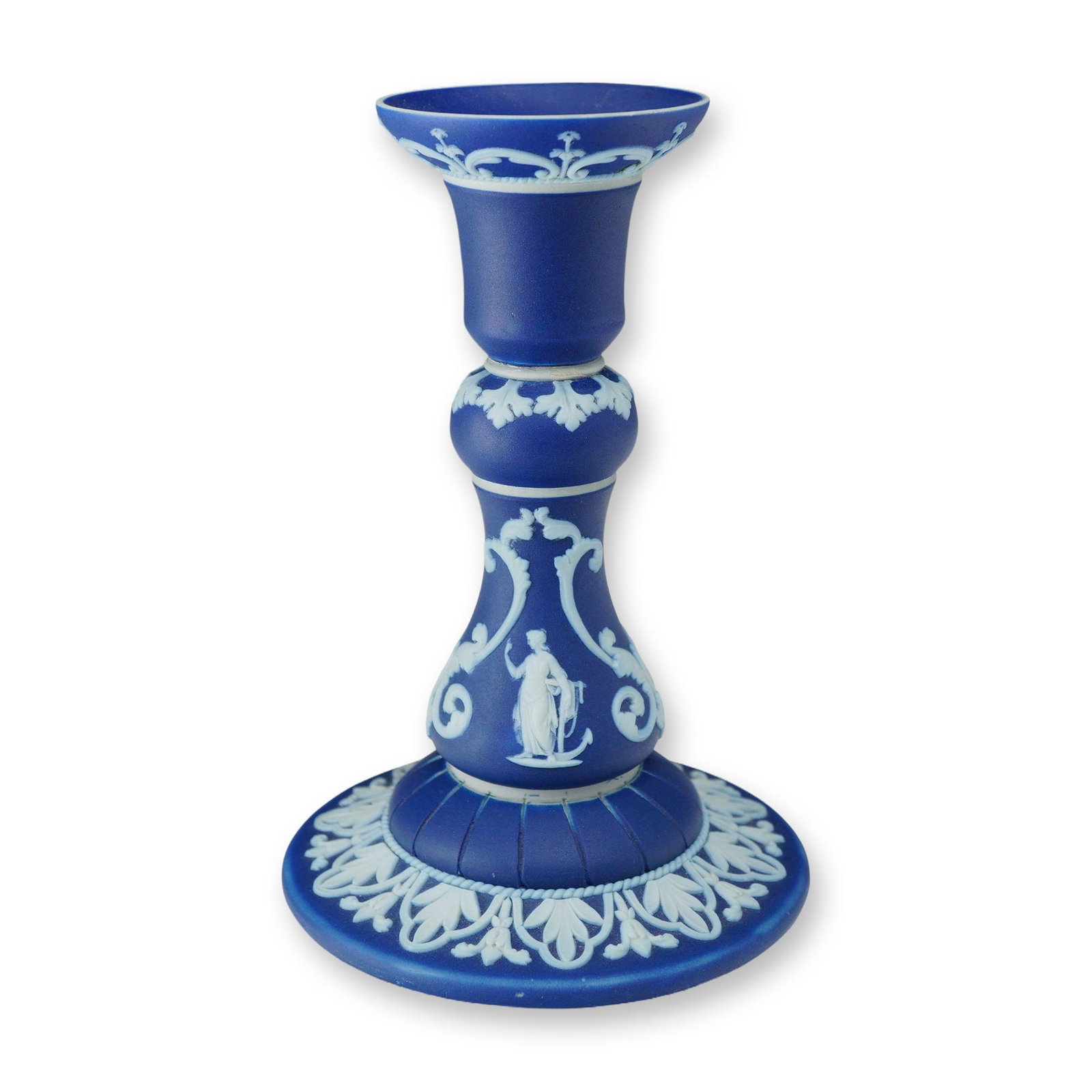 Wedgwood Cobalt Blue Jasperware Single Candlestick Holder: A Wedgwood cobalt blue jasperware single candlestick holder. This piece is crafted from fine-grained unglazed stoneware with applied white bas-relief sprigged decoration in a neoclassical style. The c