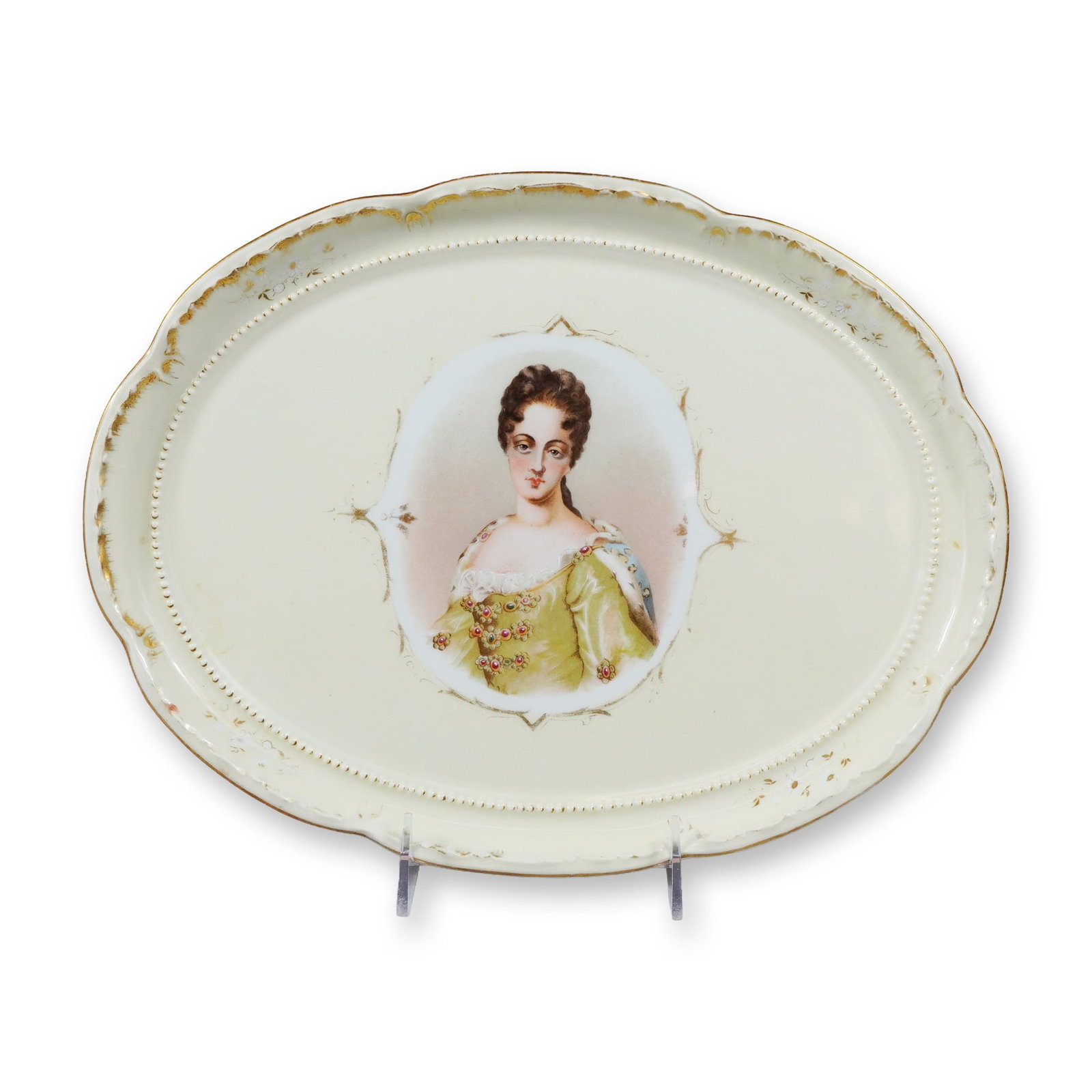German Porcelain Queen Louise Portrait Dresser Tray: A German porcelain oval dresser tray featuring a central portrait of Queen Louise of Prussia. The tray is constructed with a scalloped edge and a raised, beaded inner border on a cream-colored ground.