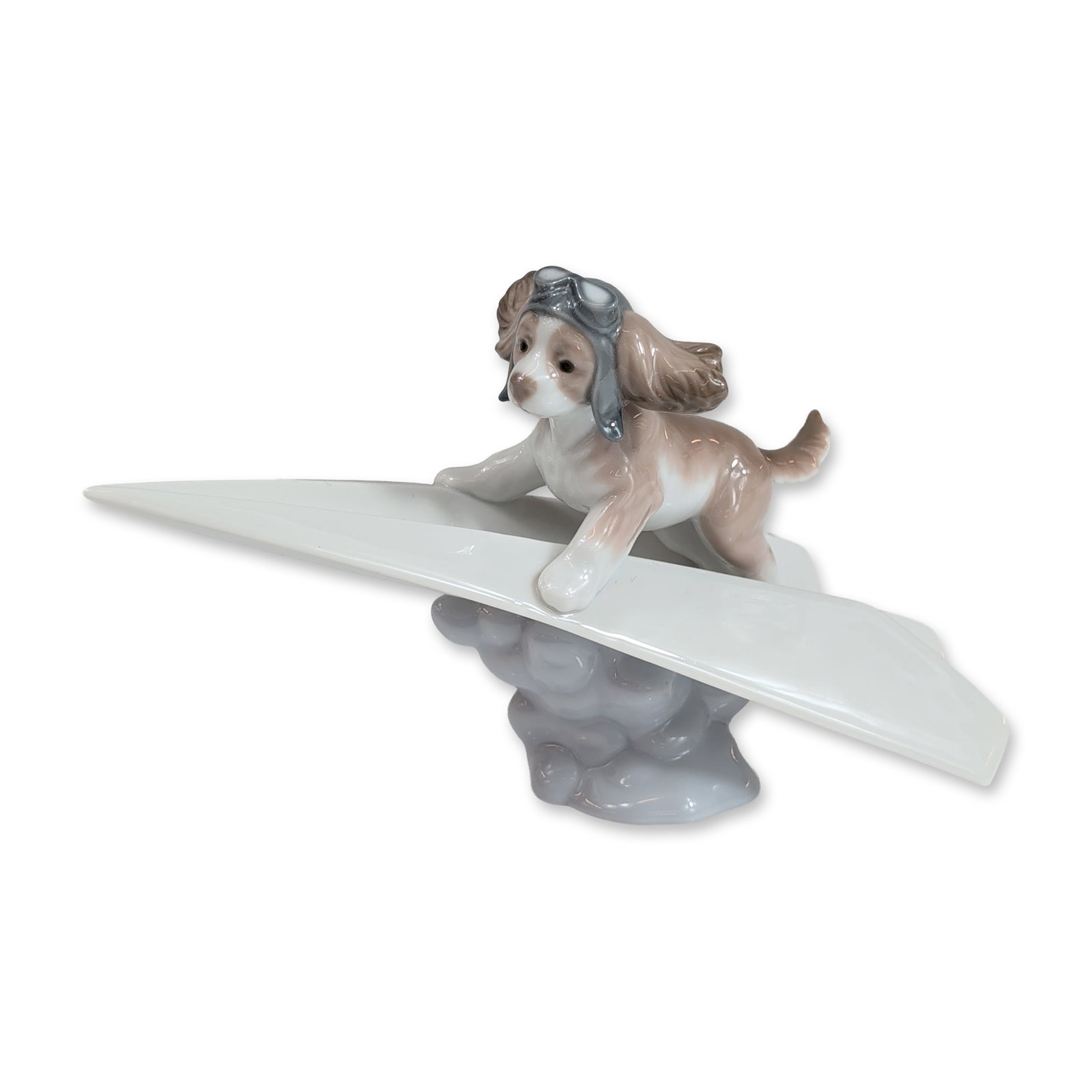 Lladro Lets Fly Away Porcelain Figurine: Lladro (Spain) glazed porcelain figurine titled Lets Fly Away, model number 6665, designed by Begona Jauregui. The piece features a brown and white spaniel puppy wearing a grey aviator cap and goggles