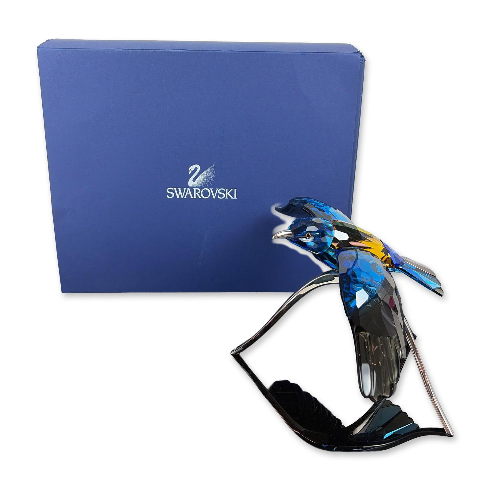 Swarovski Crystal Paradise Birds Figurine, Roller Bird: Swarovski Austrian crystal figurine titled Roller, Blue Turquoise, featuring a multi-faceted bird in vibrant shades of blue, turquoise, and yellow. The bird is mounted on a silver-toned metal stand de