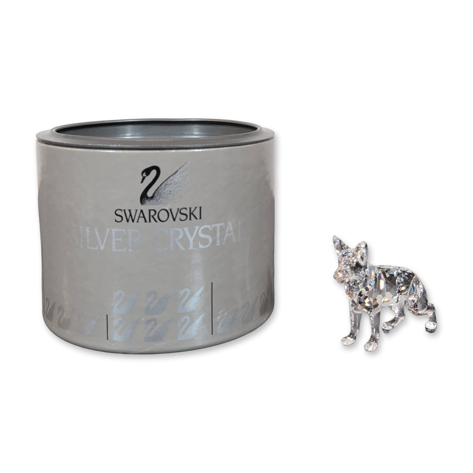 Swarovski Silver German Shepherd Figurine: Swarovski Sheppard figurine from the Silver Crystal collection in clear faceted lead crystal, featuring a faceted body and head with smooth-finished legs. The base of one paw is marked with the laser-