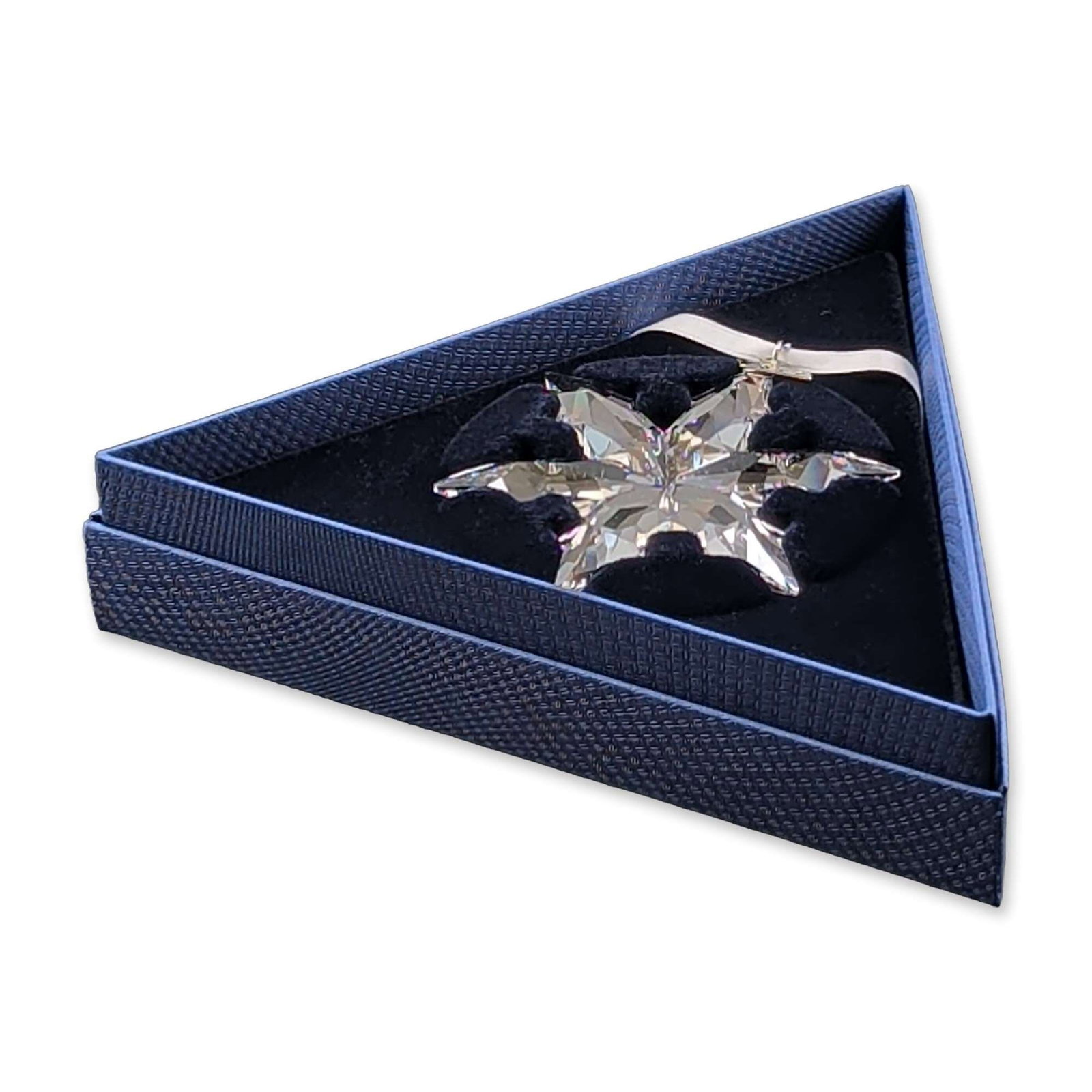 Swarovski 2015 Annual Edition Crystal Ornament: Swarovski Annual Edition 2015 Christmas ornament in clear faceted crystal, featuring a multi-pointed snowflake design. The piece includes a silver-tone metal tag engraved 2015 and is suspended from it