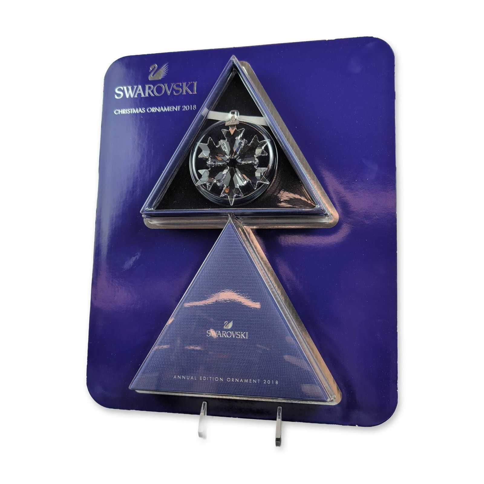 Swarovski 2018 Annual Edition Crystal Ornament: Swarovski 2018 Annual Edition Christmas ornament in faceted clear crystal, featuring a six-pointed snowflake motif set within a circular frame. The ornament is suspended from a white satin ribbon with