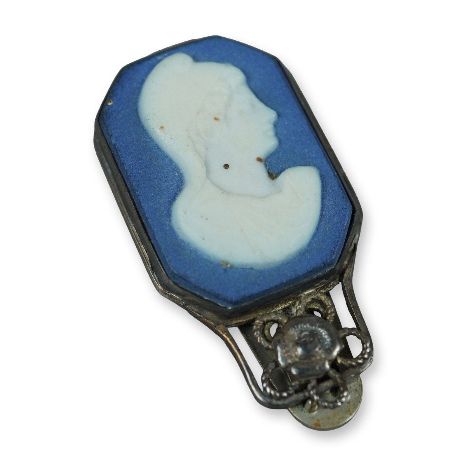 Wedgwood Sterling Silver and Blue Jasperware Cameo Dress Clip Pin: This vintage Wedgwood dress clip pin features an elongated octagonal Jasperware ceramic plaque. The plaque consists of a blue stoneware background with a white bas-relief applique depicting a classica