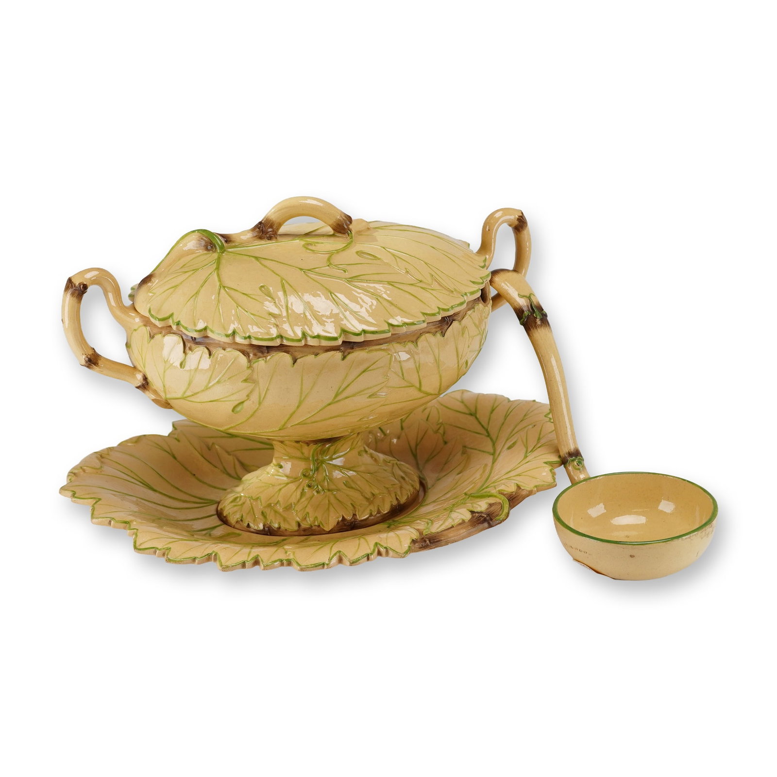 Wedgwood Majolica Leaf-Molded Soup Tureen Set: A set of English earthenware table service pieces in the majolica style, manufactured by Wedgwood. The set includes a footed soup tureen with a domed lid, a matching leaf-shaped underplate, and a