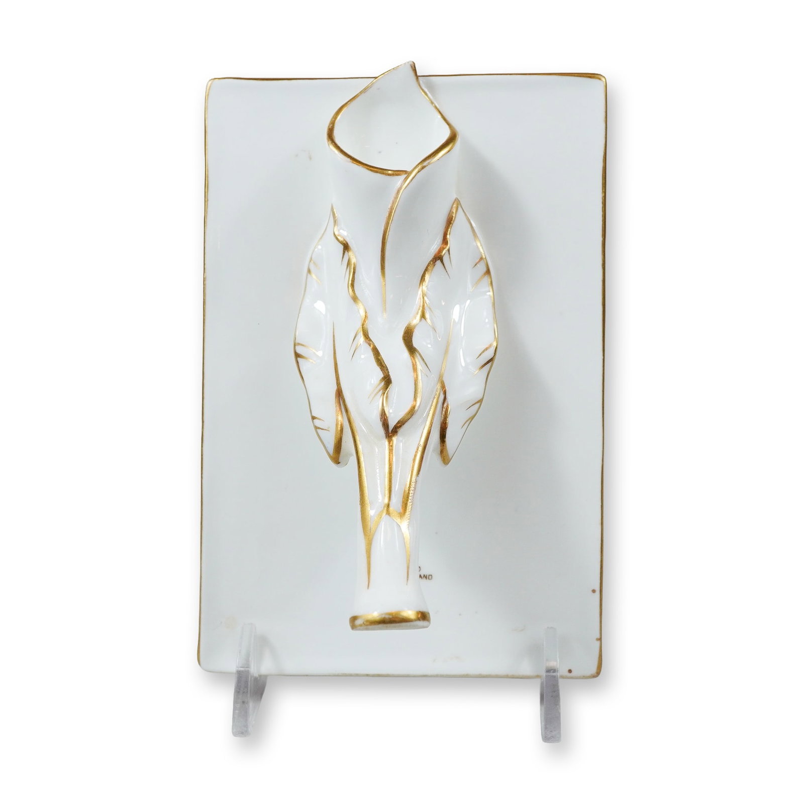 Wedgwood Gilt-Decorated White Ceramic Calla Lily Wall Pocket: A Wedgwood ceramic wall pocket featuring a high-relief stylized floral motif, specifically a calla lily, mounted on a rectangular plaque. The item is finished in a bright white glaze with