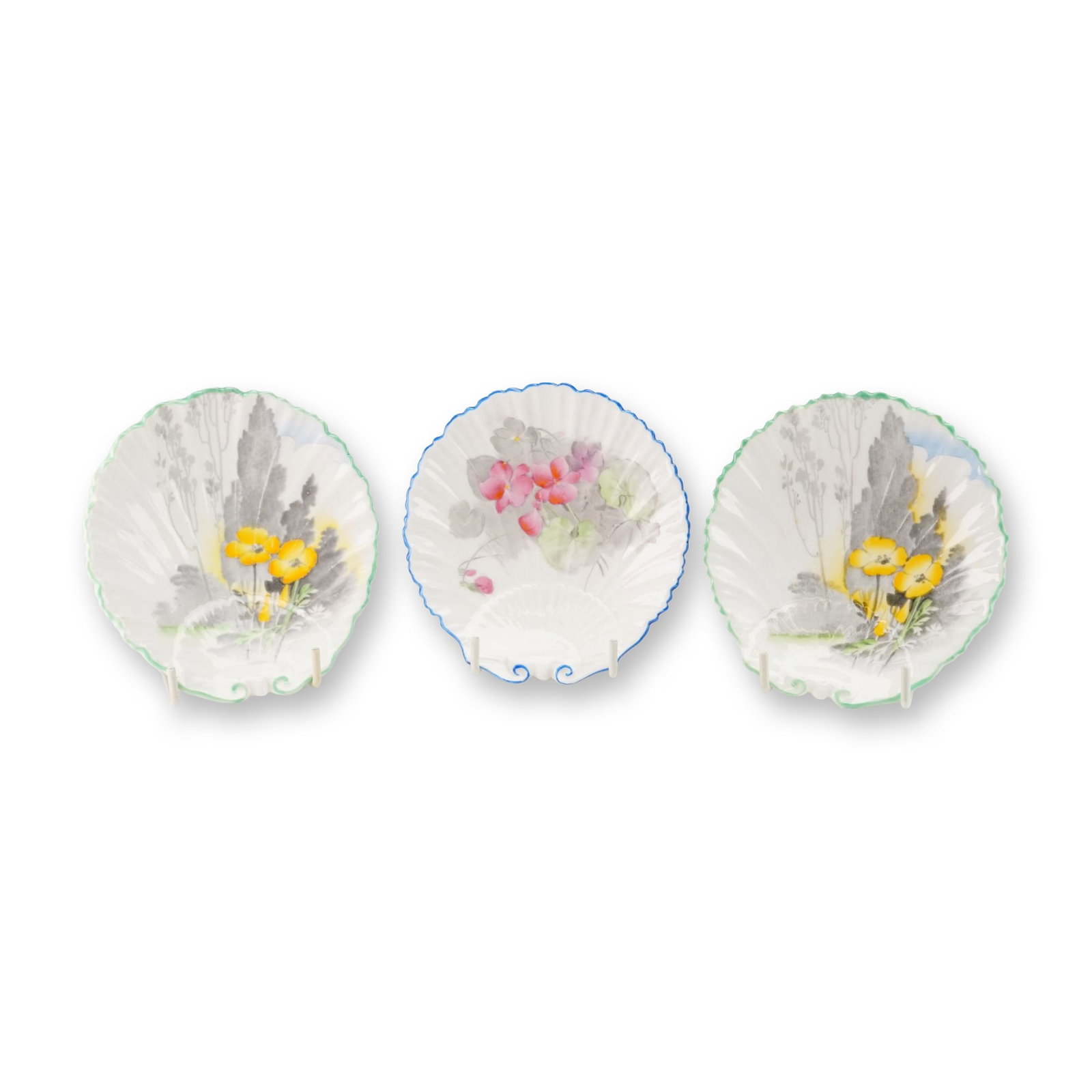 3pc Shelley England Shell Dishes: This collection of English fine bone china consists of three small Shelley England shell dishes with floral designs. Two of these fluted dishes feature yellow poppies with gray foliage and green