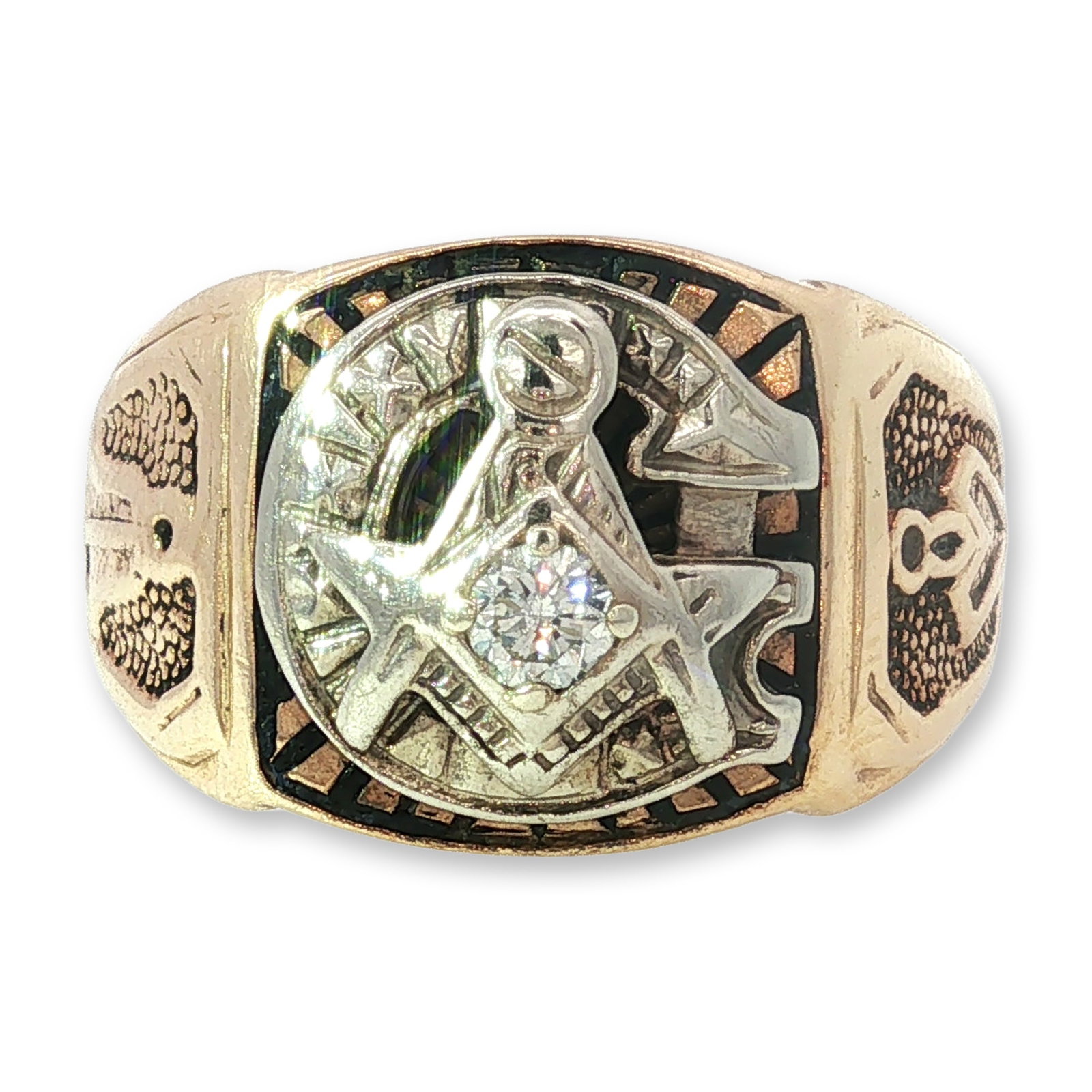 10K Gold and Diamond Masonic Signet Ring: Masonic signet ring in 10K yellow and white gold. The circular face features an applied white gold Masonic Square and compasses emblem centered with a single round brilliant-cut diamond in a prong set