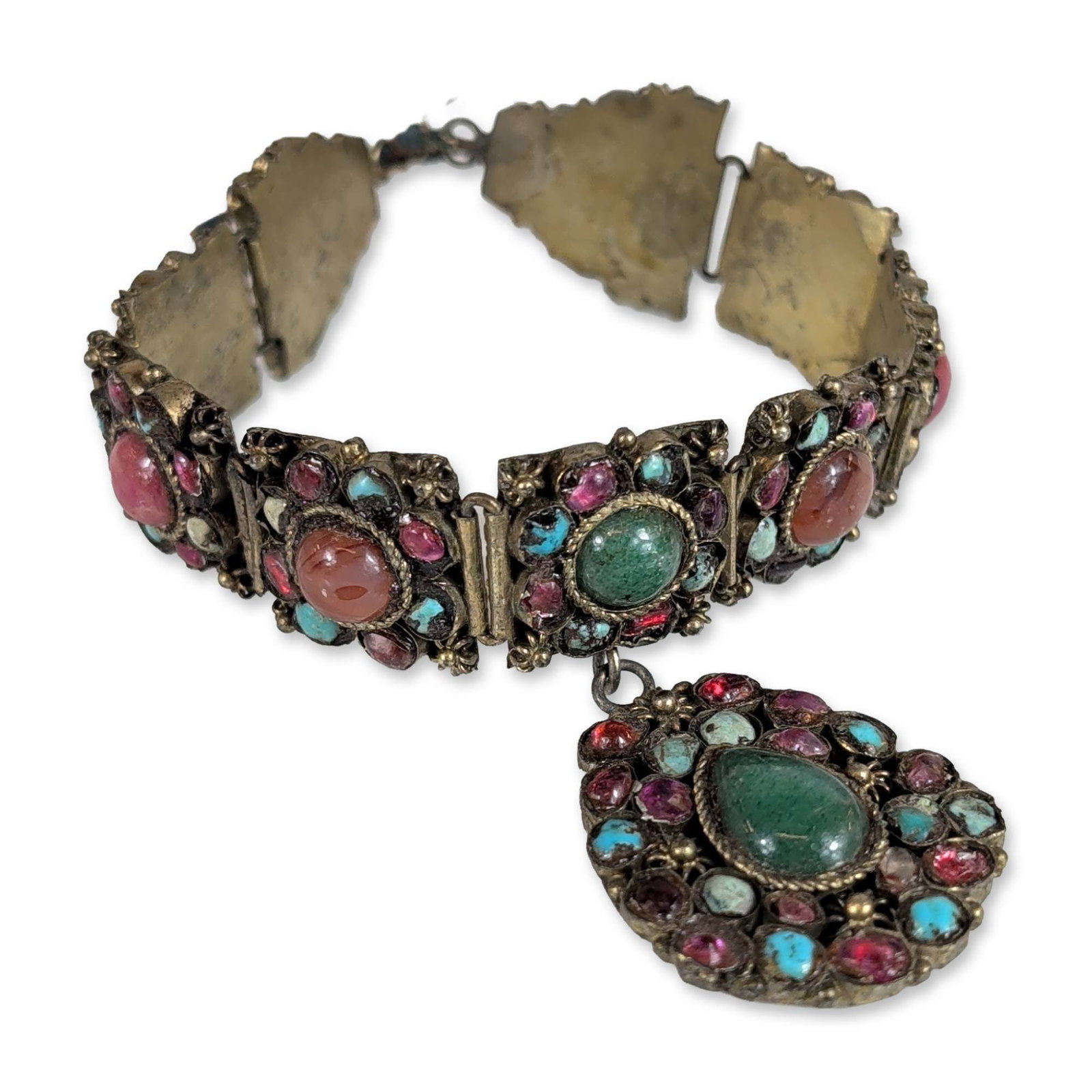 Himalayan Style Multi-Stone Gilt Metal Bracelet: Himalayan or Central Asian style multi-link panel bracelet in a gilt-tone base metal with an aged patina. The construction features articulated rectangular and triangular panels decorated with