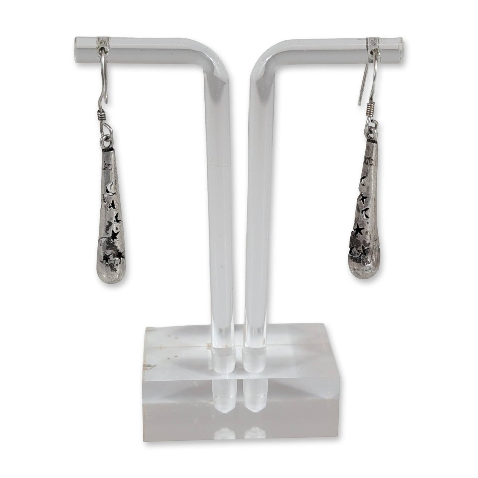 Pair of Mexican Sterling Silver Celestial Drop Earrings: Mexican sterling silver drop earrings featuring tapered conical forms with pierced celestial motifs of stars and crescent moons. Suspended from shepherd's hook ear wires. Stamped MEXICO and MEX on the