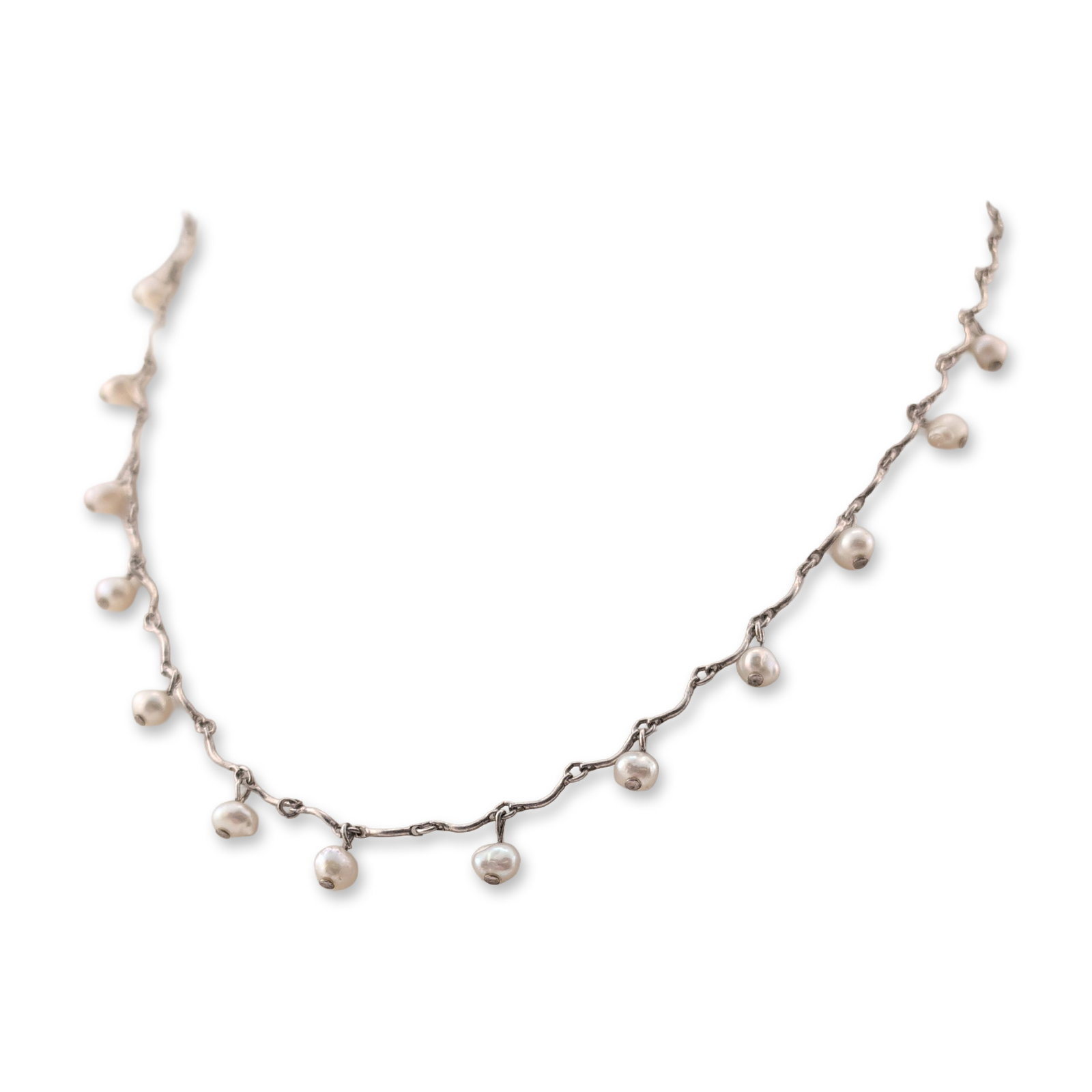 Sterling Silver Baroque Pearl Station Necklace: Vintage station necklace featuring small white-to-cream baroque cultured pearls. Each pearl is wire-wrapped and suspended from a decorative chain constructed of curved bar links joined by circular jum