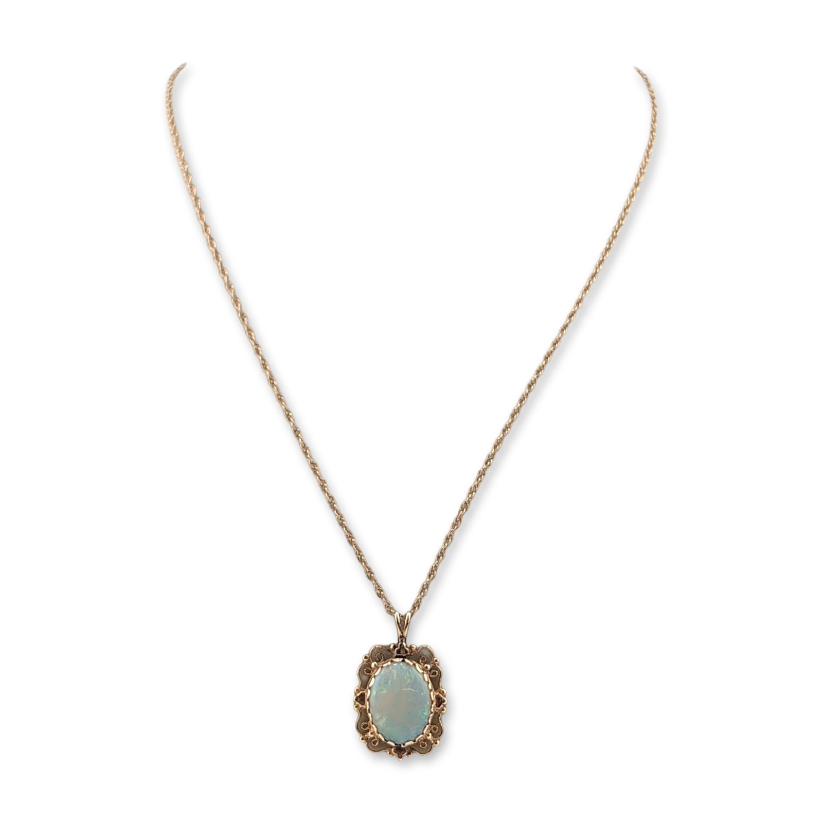14K Yellow Gold and Opal Filigree Pendant and Necklace: This 14K yellow gold filigree pendant showcases a stunning oval iridescent opal, gracefully hanging from a 14K yellow gold twist chain with a secure lobster claw clasp. Metal and gemstone details are 