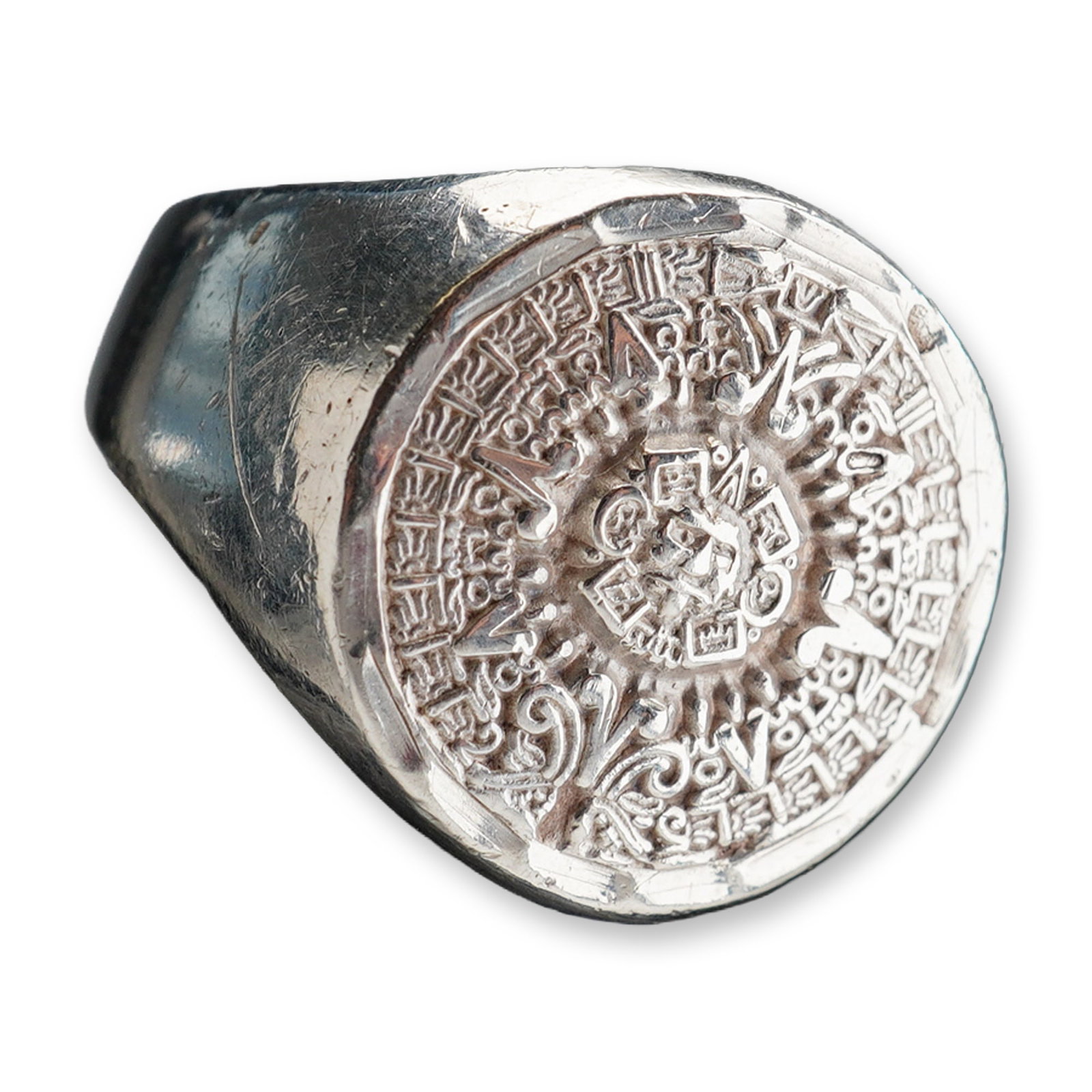 Mexican Sterling Silver Aztec Calendar Ring: A sterling silver signet ring engraved with the Aztec calendar. The band is marked 925. Dimensions: Ring size: 9.5 Weight: 10.8 g