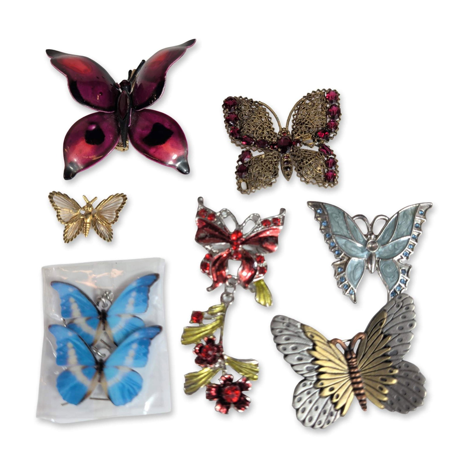9pc Butterfly Themed Jewelry: A collection of seven butterfly themed jewelry pieces, featuring one large textured two tone silver and gold tone metal brooch by Razza. The assortment includes various styles such as a magenta enamel