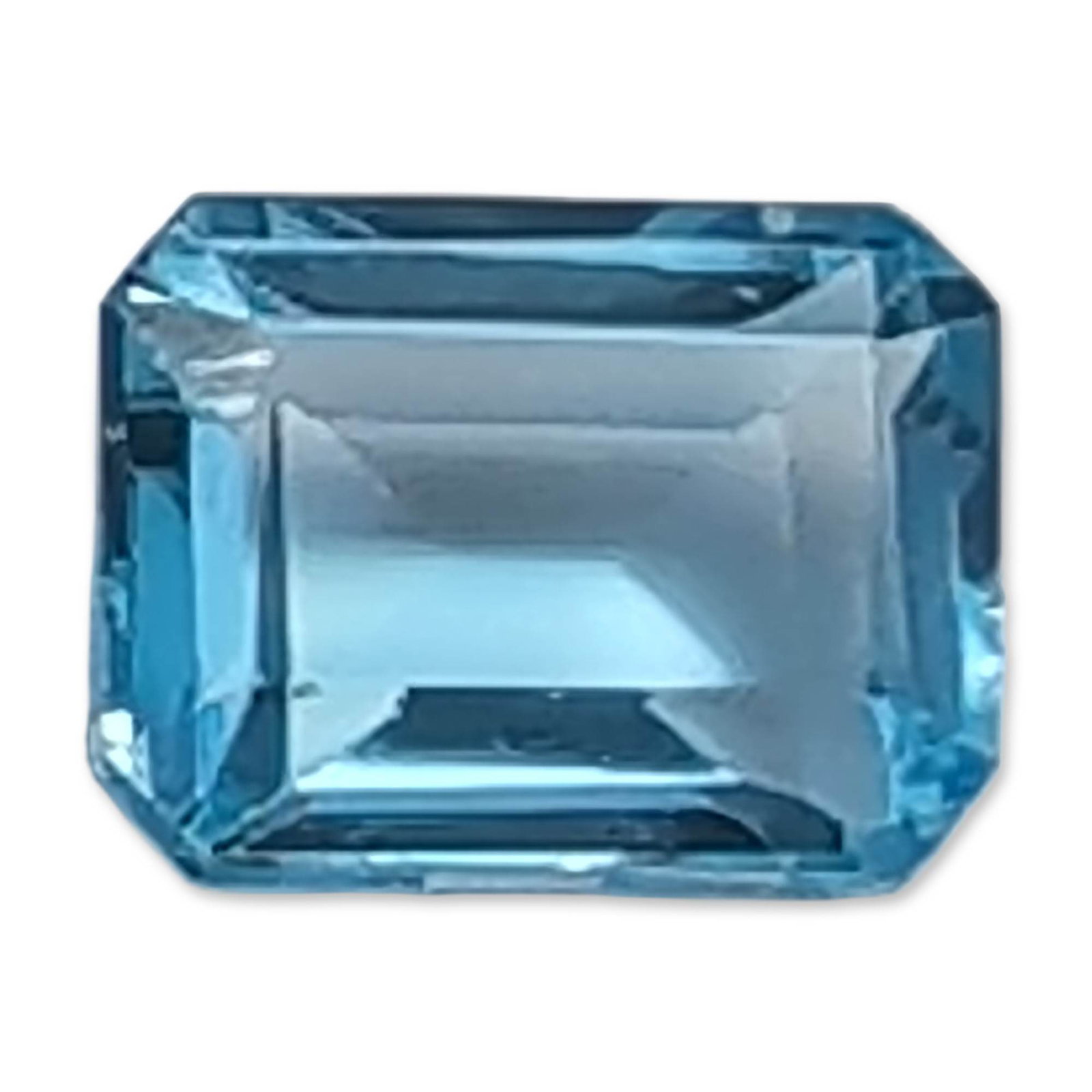 Emerald Cut Blue Topaz Style Gemstone: Loose faceted Topaz gemstone in a saturated blue. The stone is fashioned in a rectangular emerald cut, featuring high transparency and an eye-clean appearance.3.5ct and 9.0mm Dimensions: 9.0mm