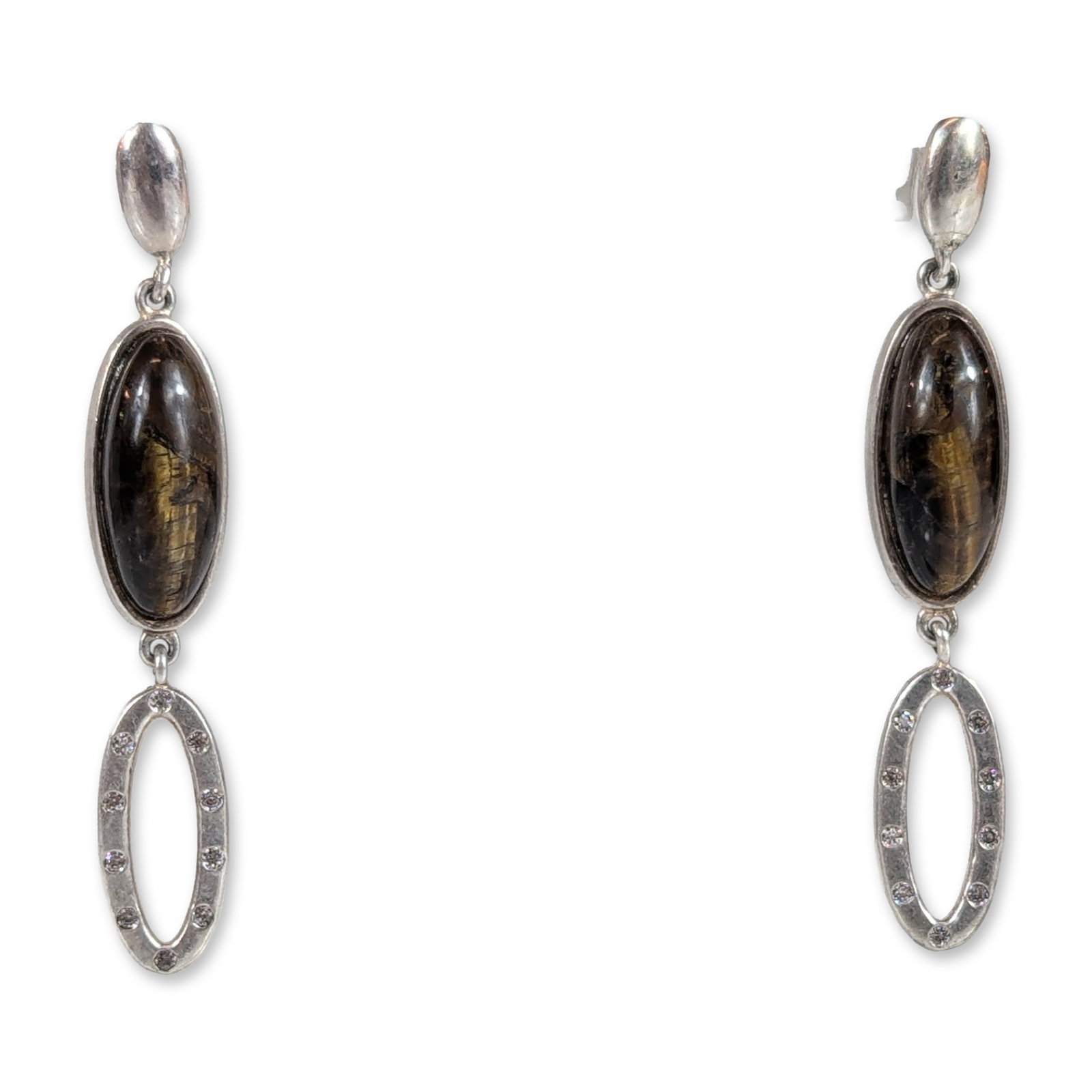 Belatriz Sterling Silver and Tiger Eye Drop Earrings: Belatrix. A pair of articulated drop earrings in sterling silver, featuring central bezel-set oval cabochon tiger eye gemstones displaying chatoyant golden-brown bands. The design consists of a solid 