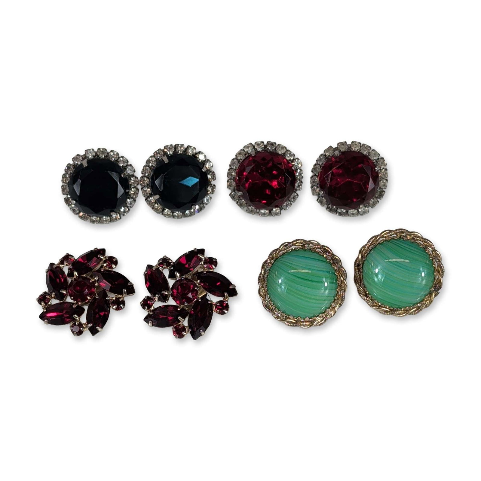 Assortment of Vintage Mid-20th Century Costume Jewelry Earrings: Group of four pairs of vintage mid-20th-century costume jewelry earrings. The lot includes a pair of Sarah Coventry gold-tone earrings featuring green marbled glass cabochons in a twisted-rope border,