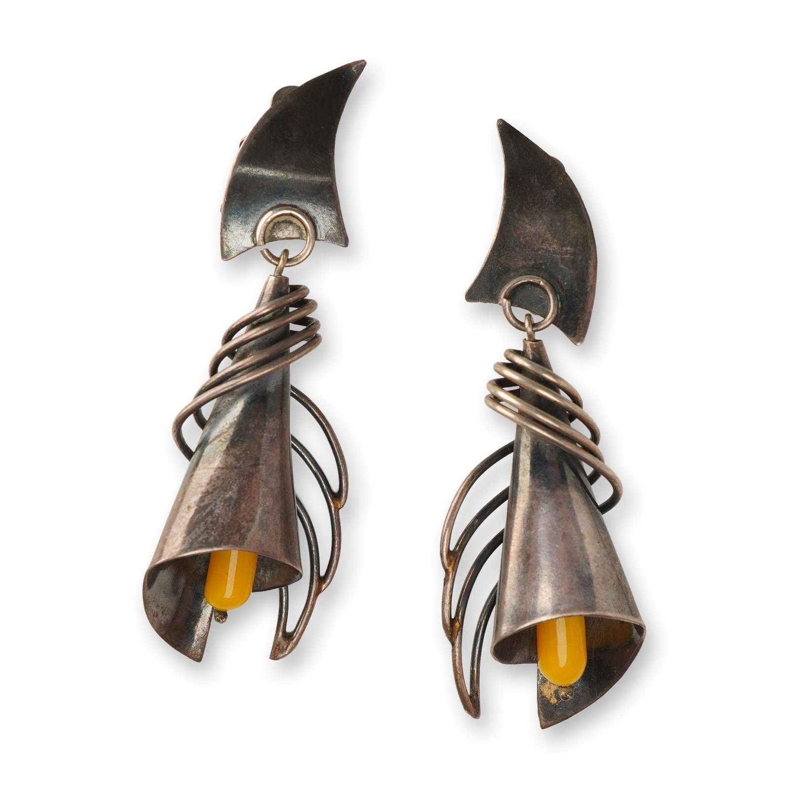 Pair of Modernist Silver-Toned Calla Lily Clip-On Drop Earrings: This matched pair of clip-on drop earrings features a modernist artisanal design with a stylized calla lily motif. Each earring is composed of a curved upper segment from which a large floral drop is 