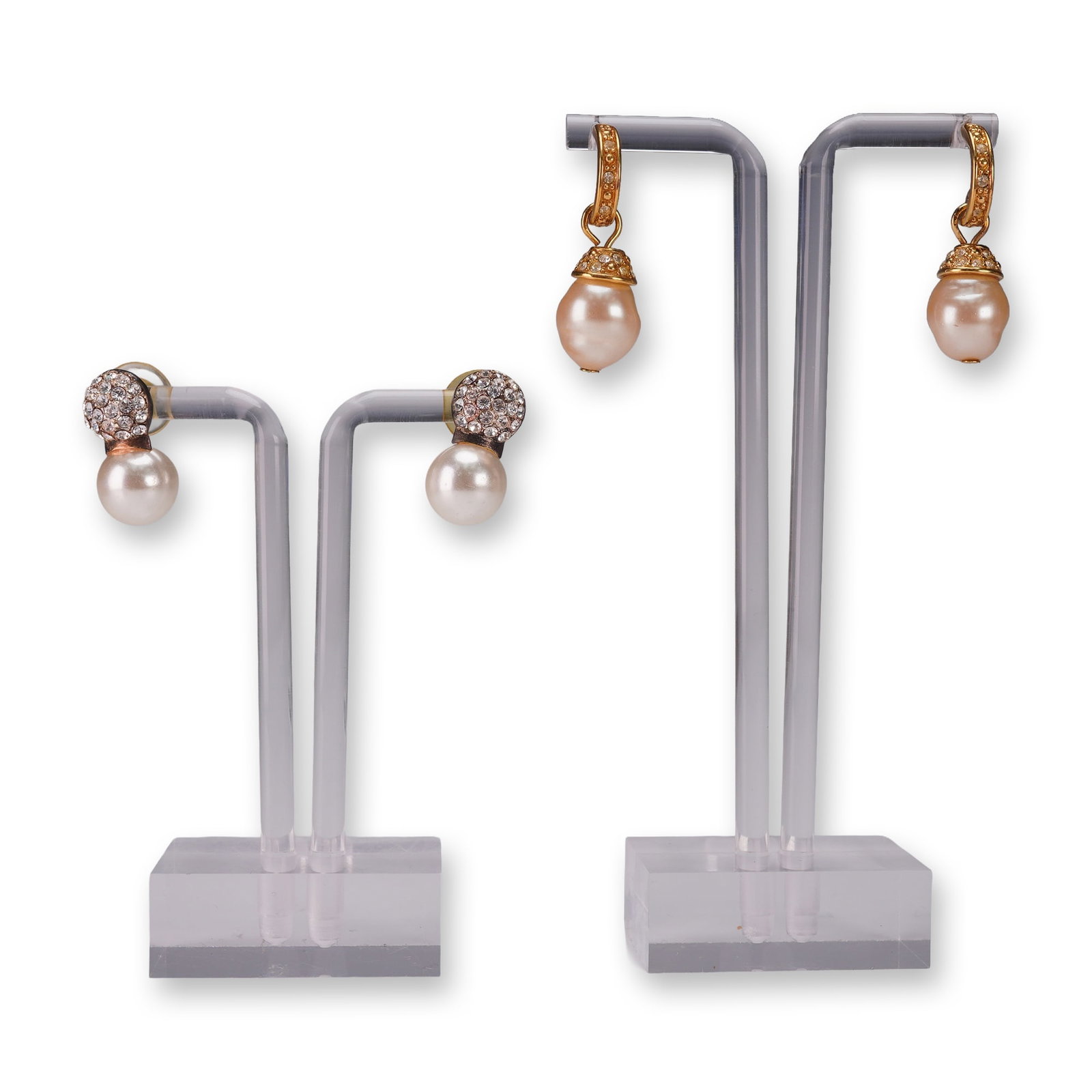 2 Pair Rhinestone and Faux Pearl Earrings: Group of two pairs of glamorous rhinestone accented earrings. The first pair features luminous faux pearls suspended from pave rhinestone caps set in a goldtone mount, offering a chic drop design. The