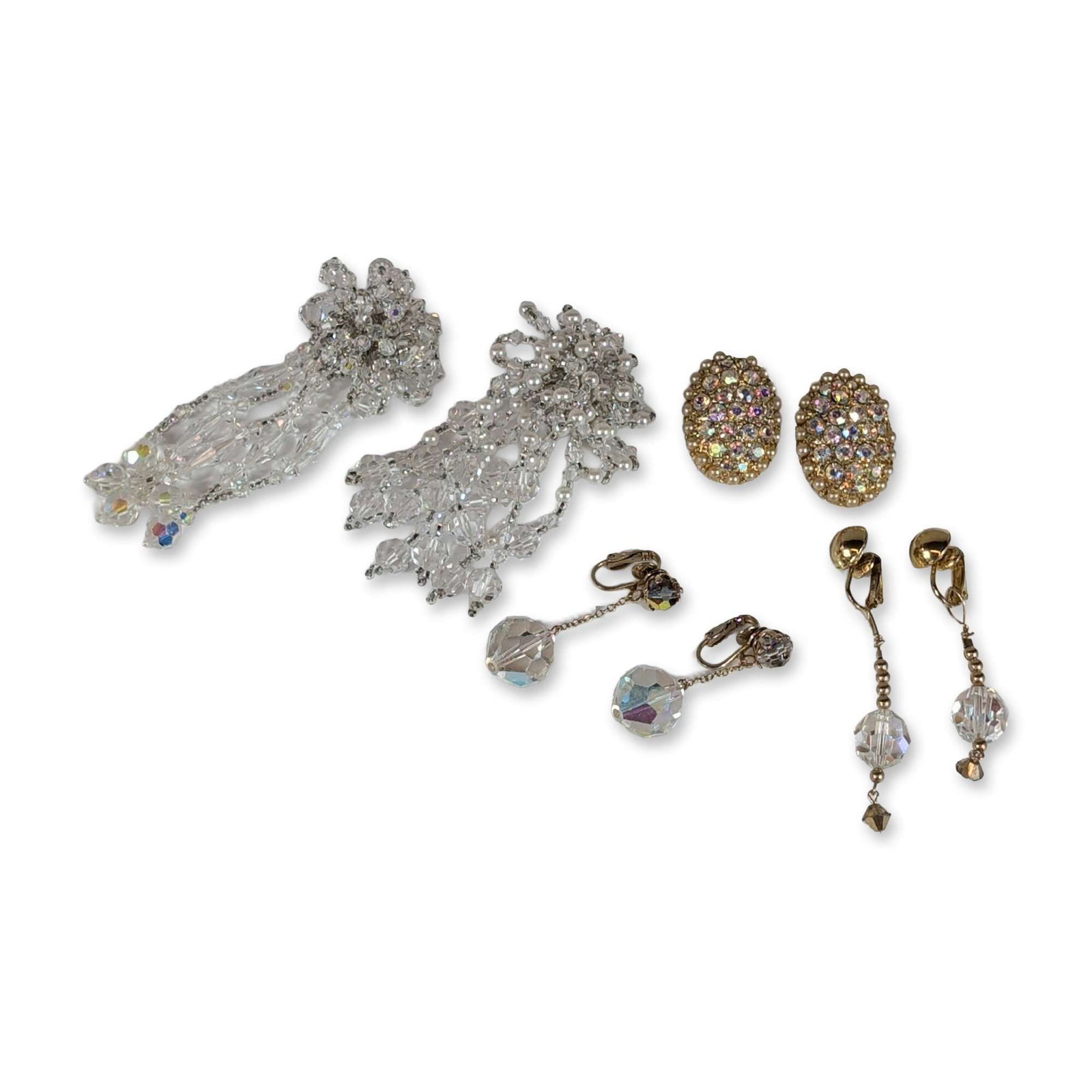 4 Pairs of Vintage Crystal Earrings: Mid-20th century collection of four pairs of costume clip-on earrings featuring Aurora Borealis (AB) faceted glass crystals, rhinestones, and faux seed pearls. The assortment includes a matched pair o
