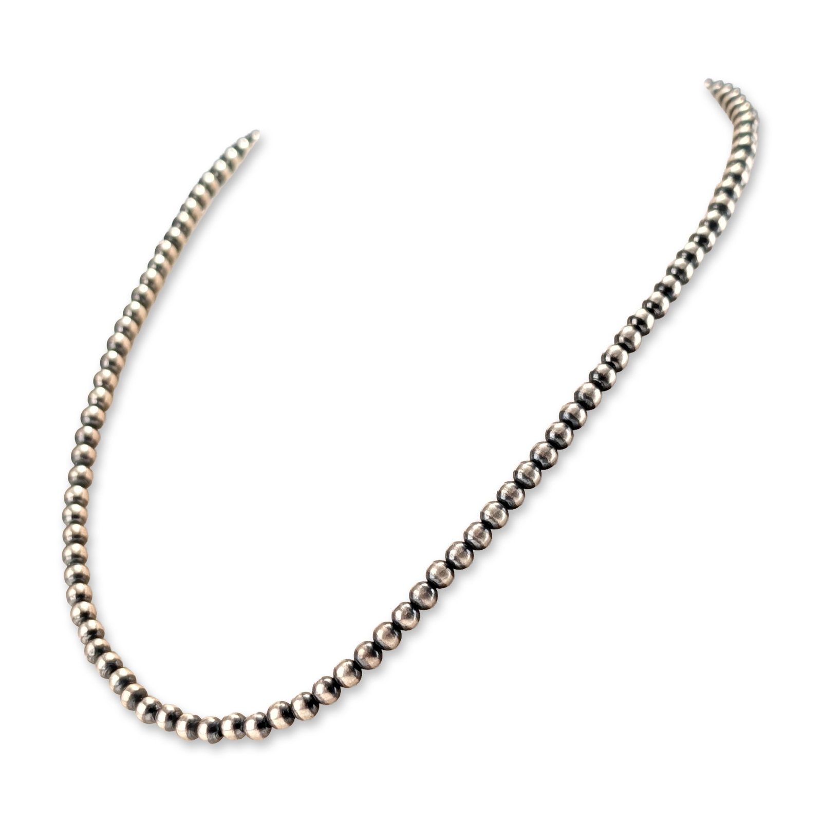 Southwestern Sterling Silver Bead Necklace: Southwestern style single-strand necklace composed of uniform spherical sterling silver beads with a polished finish and intentional oxidation around the drill holes, a design referred to as Navajo pe