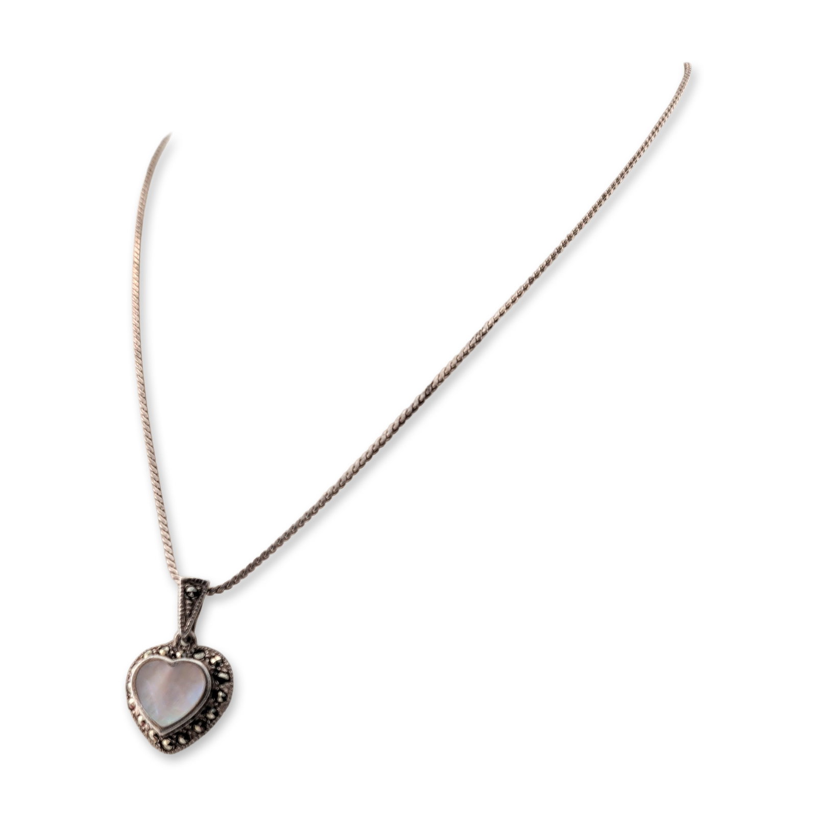 Sterling Silver Marcasite and Mother-of-Pearl Heart Necklace: Sterling silver pendant necklace featuring a heart-shaped mother-of-pearl cabochon center. The central stone is bordered by small, faceted marcasite accents, with additional marcasite stones set into 