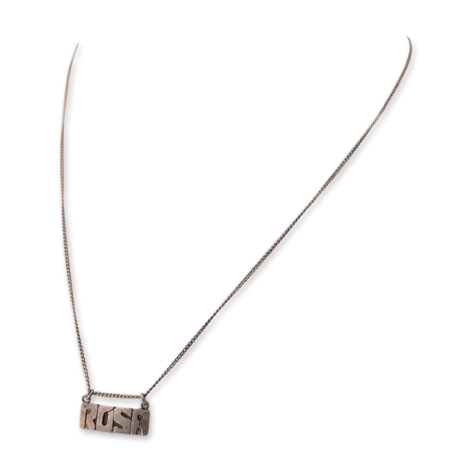 Sterling Silver Personalized Rosa Nameplate Necklace: Sterling silver necklace featuring an integrated nameplate pendant with stylized cutout block letters spelling Rosa. The pendant is attached to a fine curb link chain secured by a spring-ring clasp. T