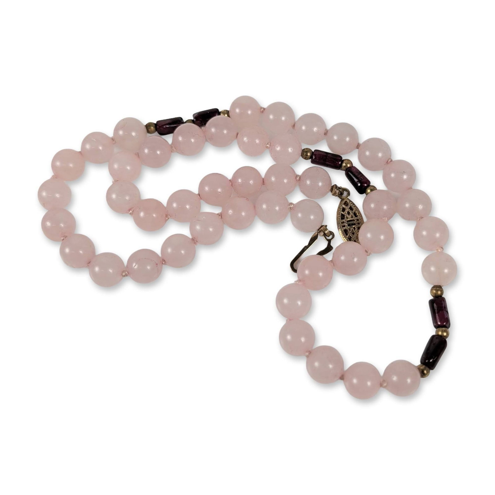 14K Gold Rose Quartz Necklace: Vintage estate beaded necklace featuring polished round rose quartz beads accented by dark reddish-purple barrel-shaped beads and gold-toned spacers. The necklace is hand-knotted and finished with a g